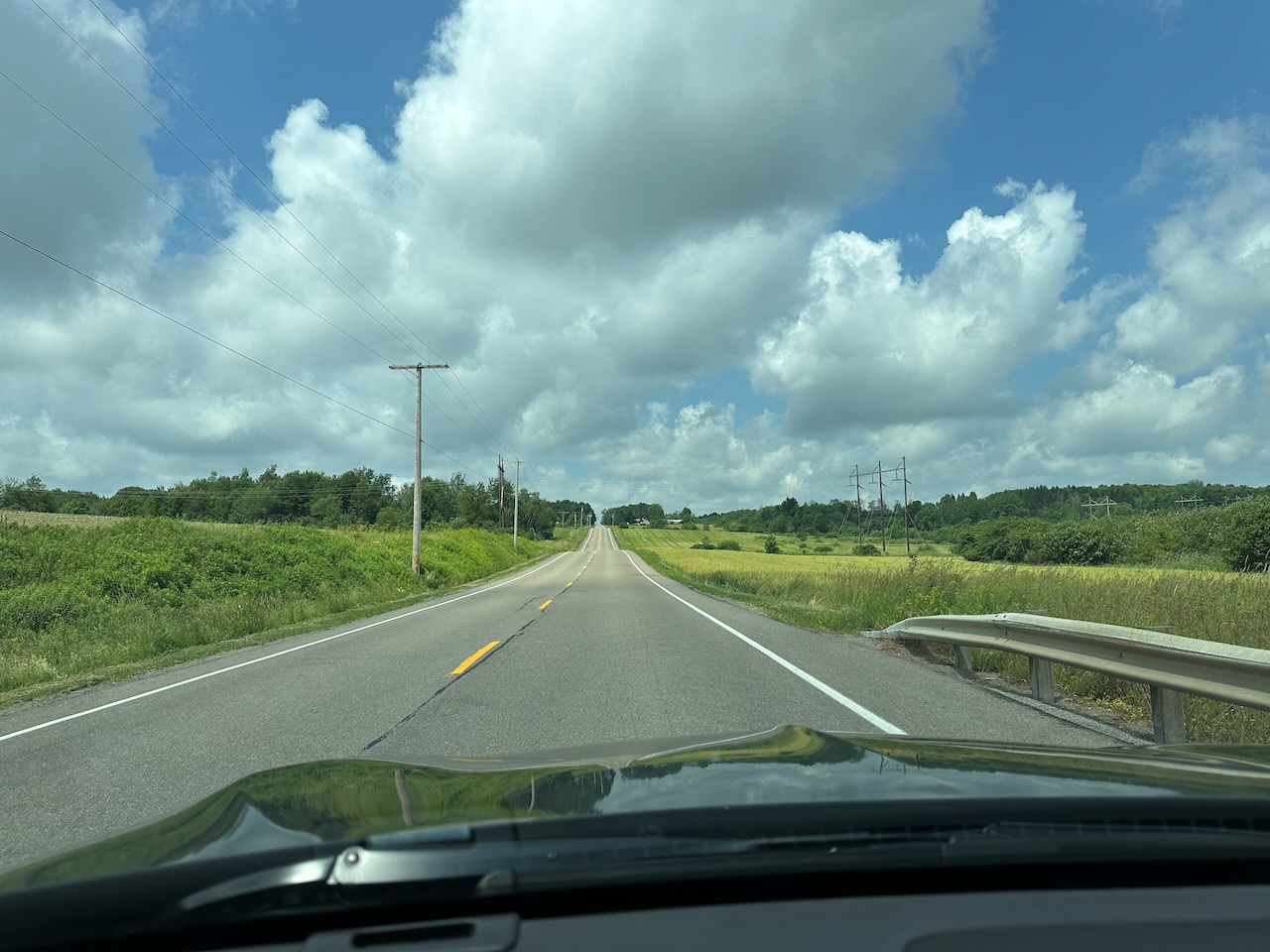 View of two-lane county road through rural section of New York. 