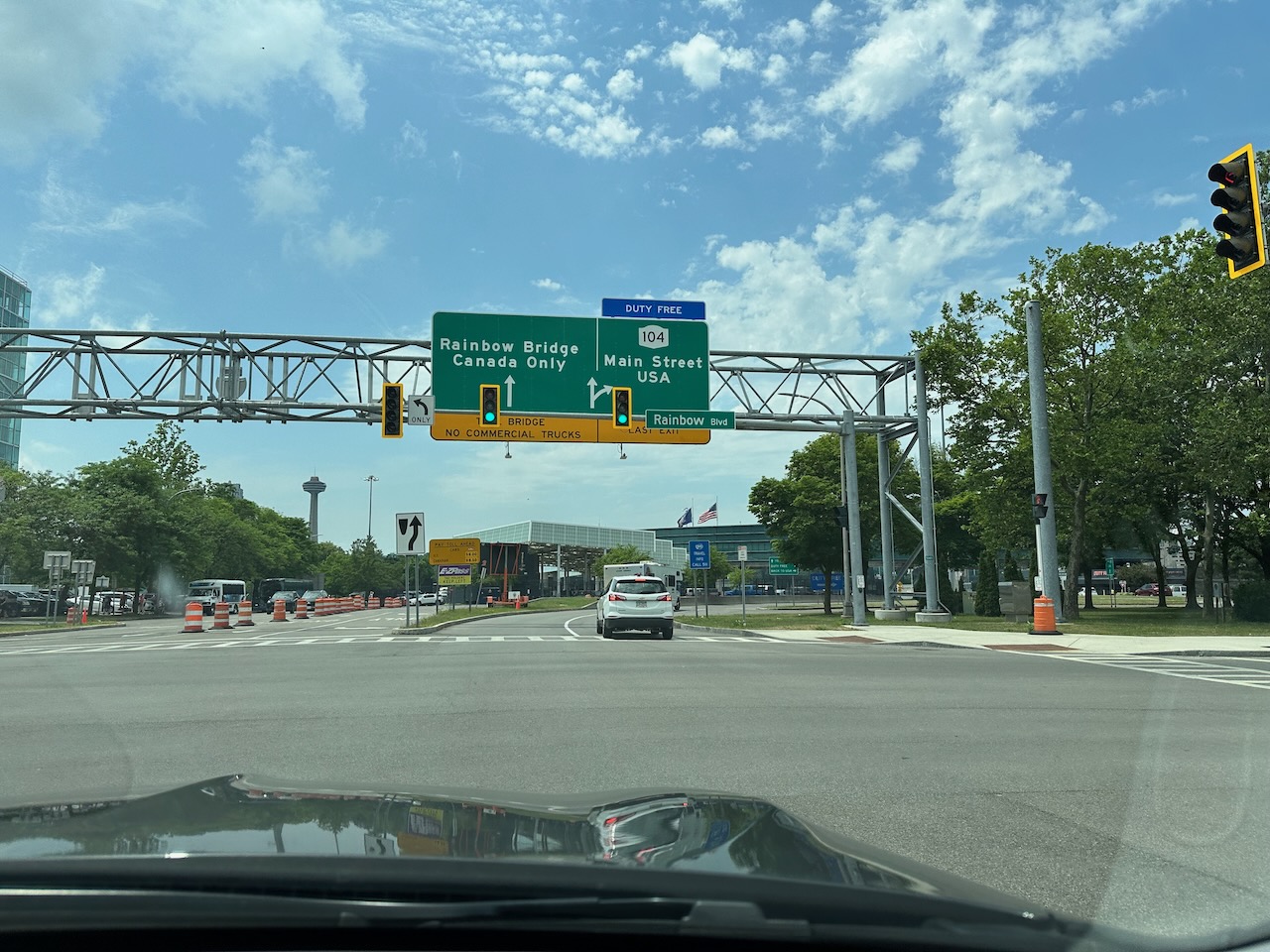 Sign over city street pointing toward Rainbow Bridge.