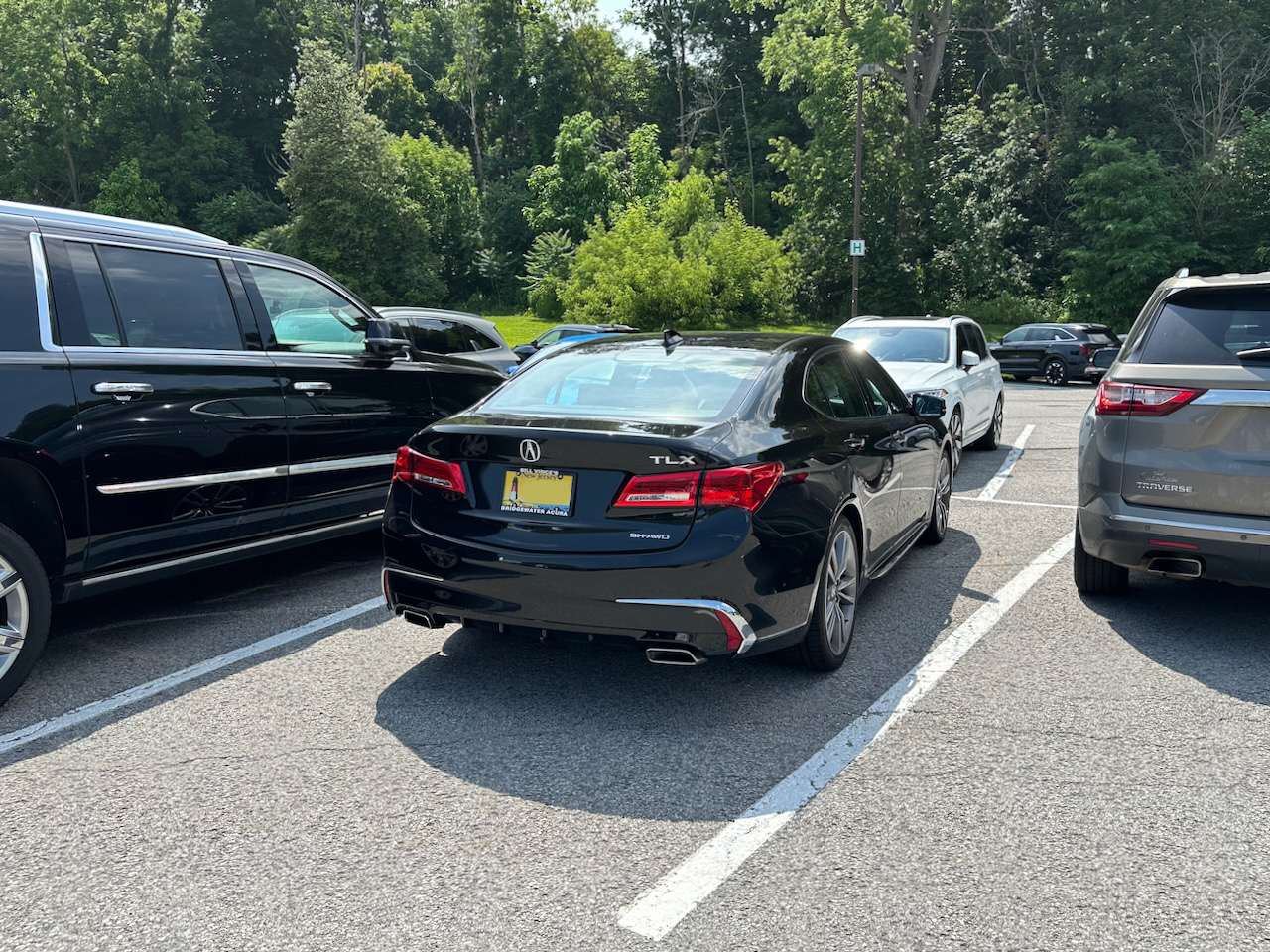 2020 Acura TLX parked in parking lot, surrounded by other vehicles.
