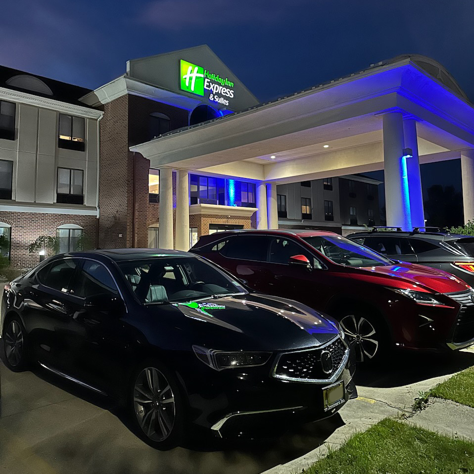 2020 Acura TLX parked in front of Holiday Inn Express hotel. 