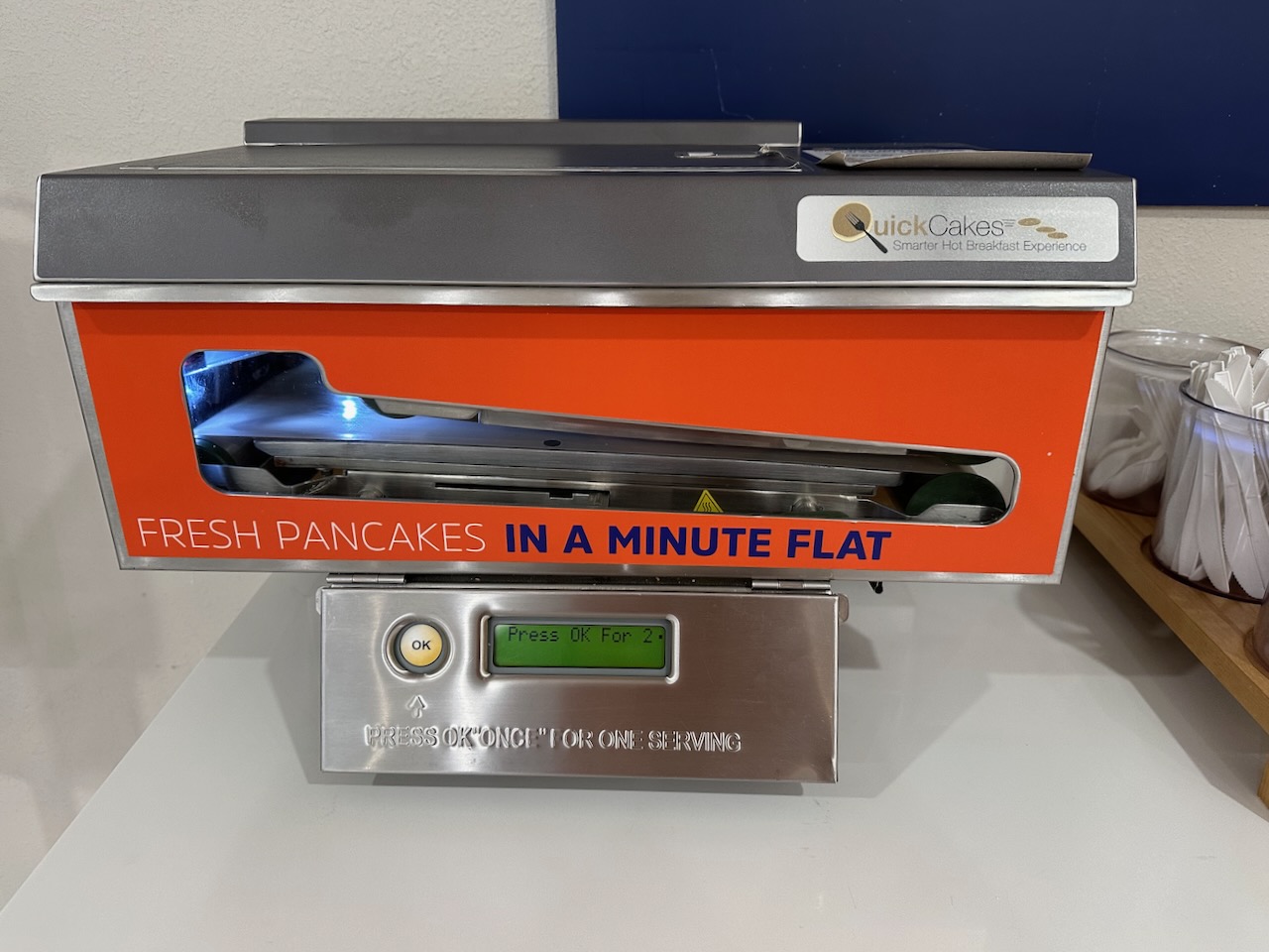 Pancake making machine in hotel dining area.