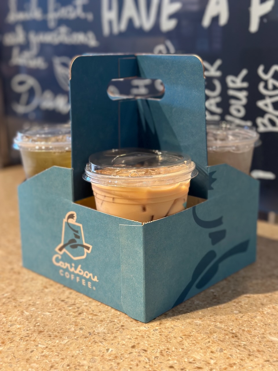 Beverage carrier for Caribou coffee, with three iced beverages in carrier.