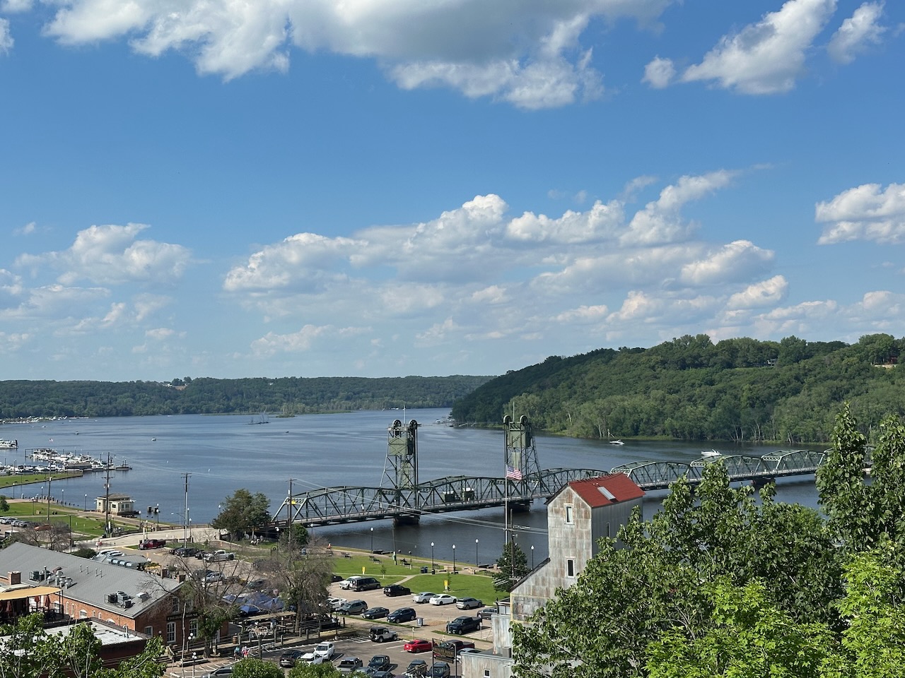 View from top of scenic overlook of Stillwater. The St. Croix River, the Lift Bridge, and the downtown area are all in view.