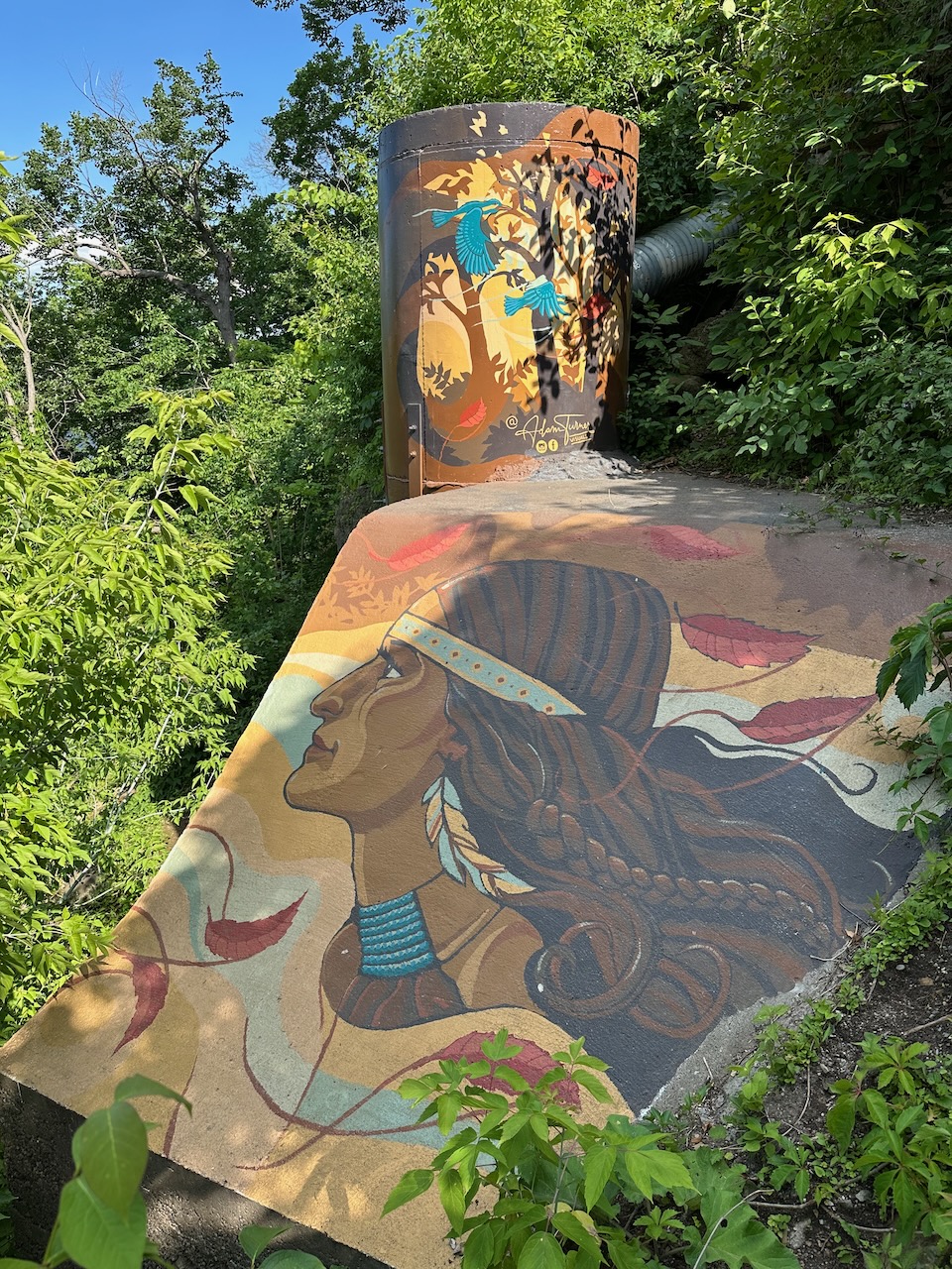 Mural on rocks beside stairs.