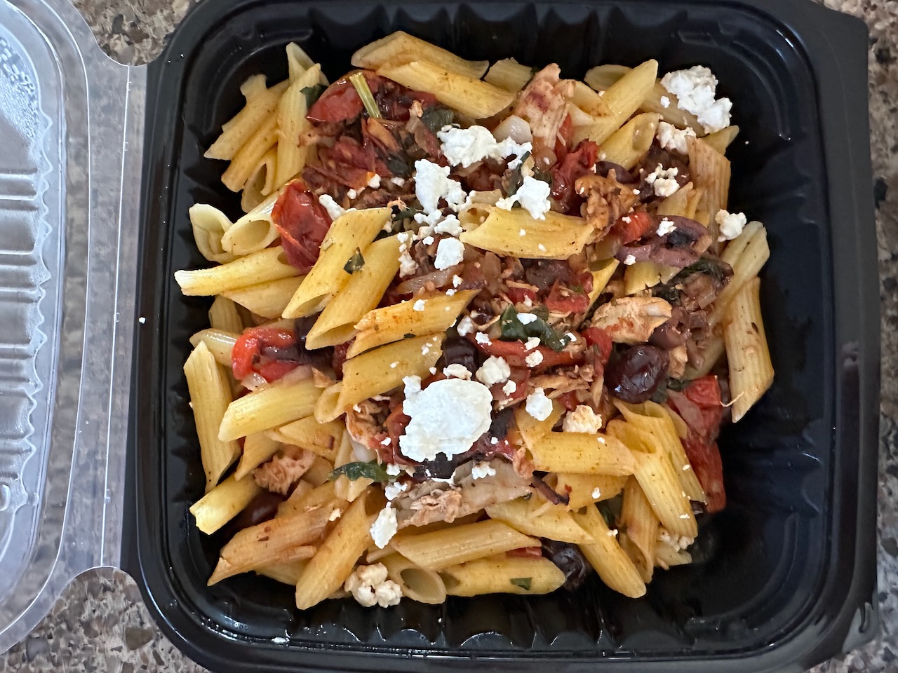Mediterranean pasta in takeout container.