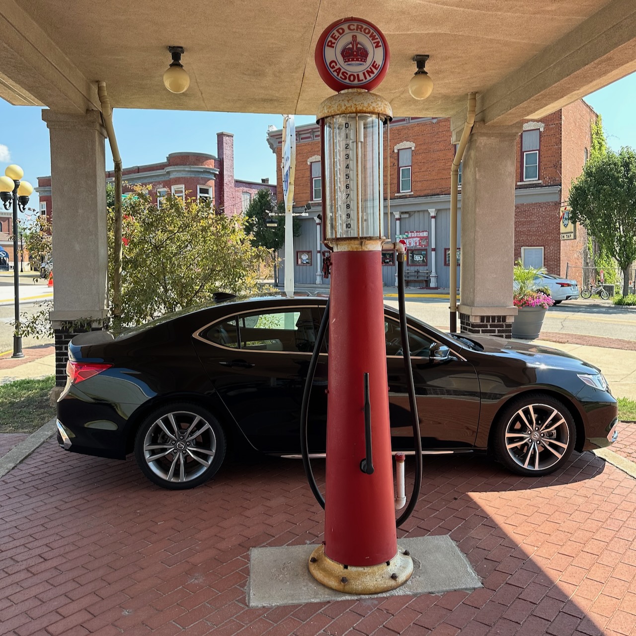 2020 Acura TLX parked behind historic fuel pump.