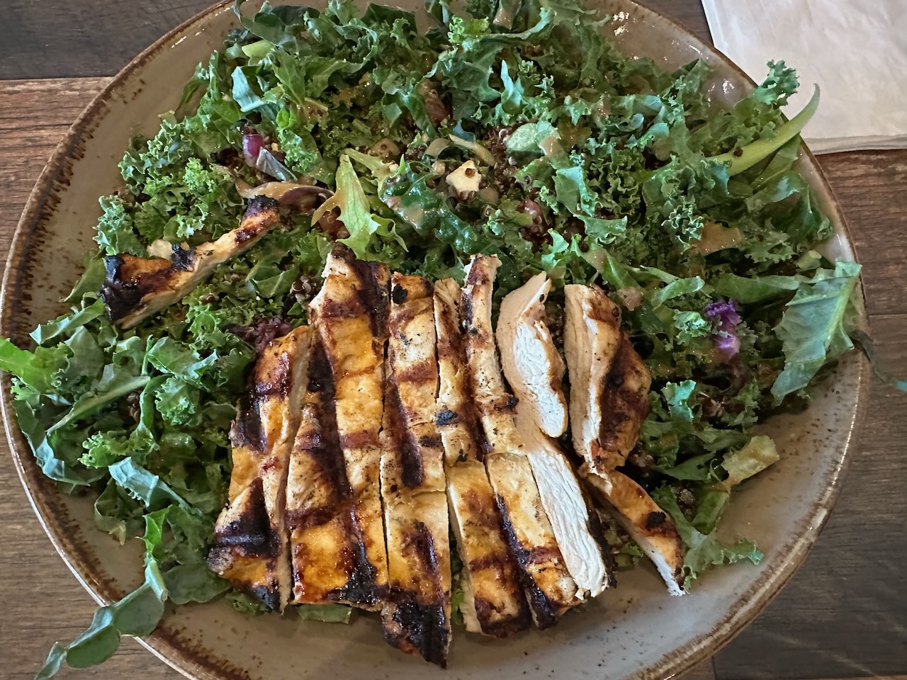 Kale and quinoa bowl with grilled chicken.