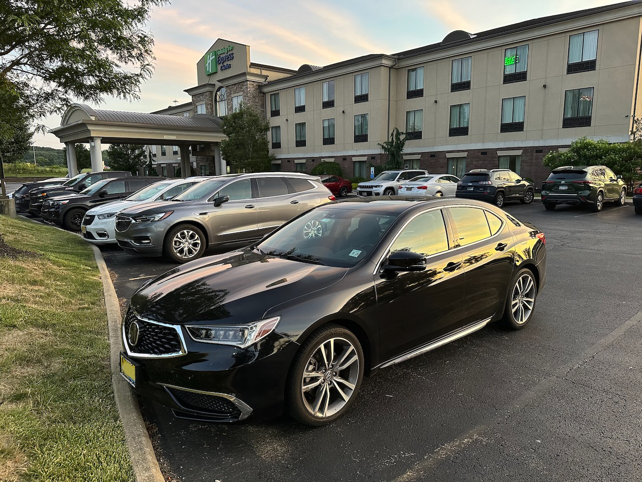 2020 Acura TLX parked in front of a hotel.