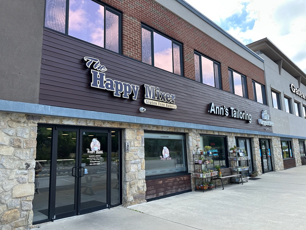 Exterior of The Happy Mixer bakery in strip mall. 
