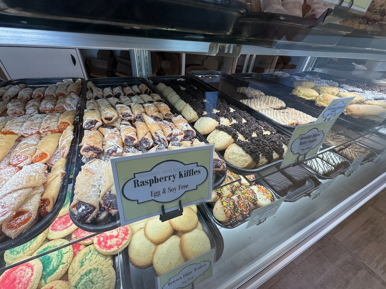 Cookies and other baked goods on shelves in cooler.
