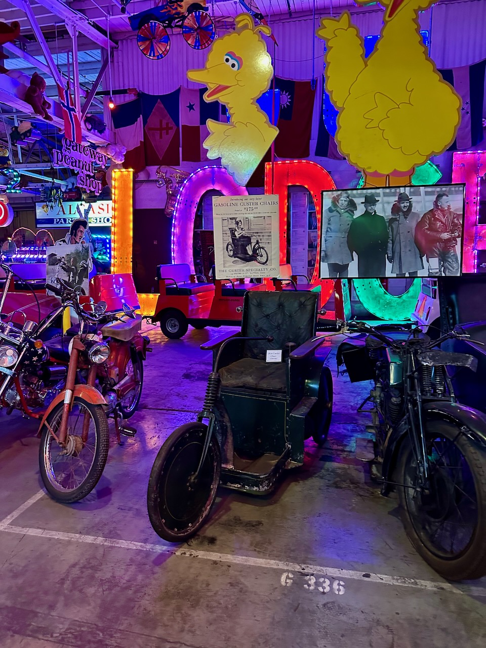 Lineup of motorcycles with 1916 Custer Chair in middle.