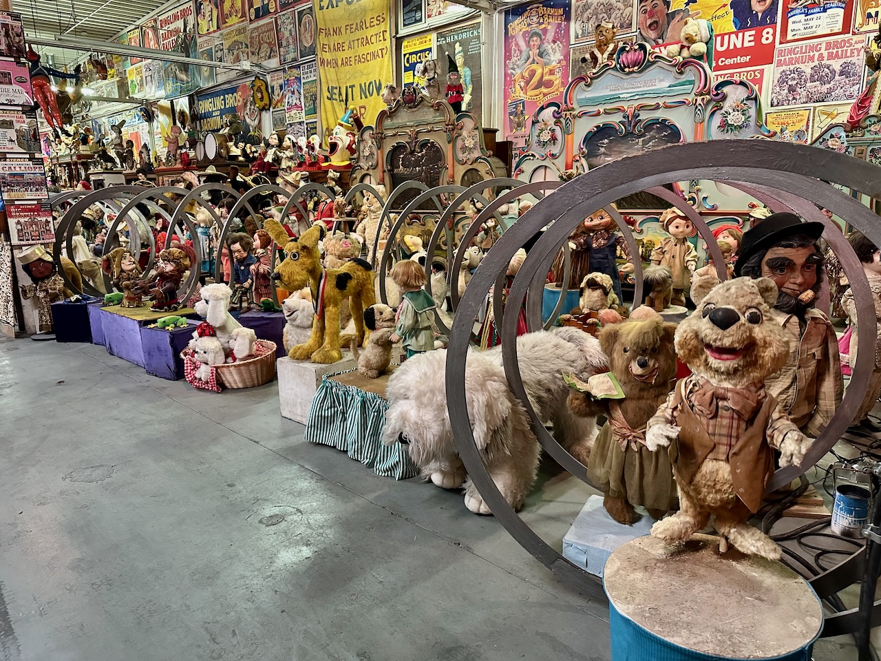 World's Largest Slinky on display, with numerous dolls in and around it.