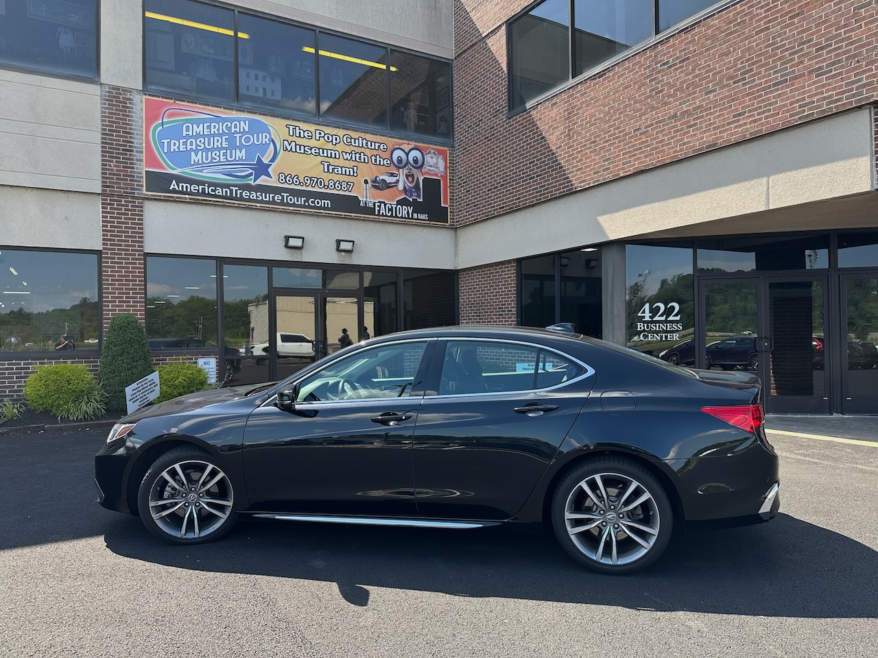 2020 Acura TLX parked in front of entrance to American Treasure Tour Museum.