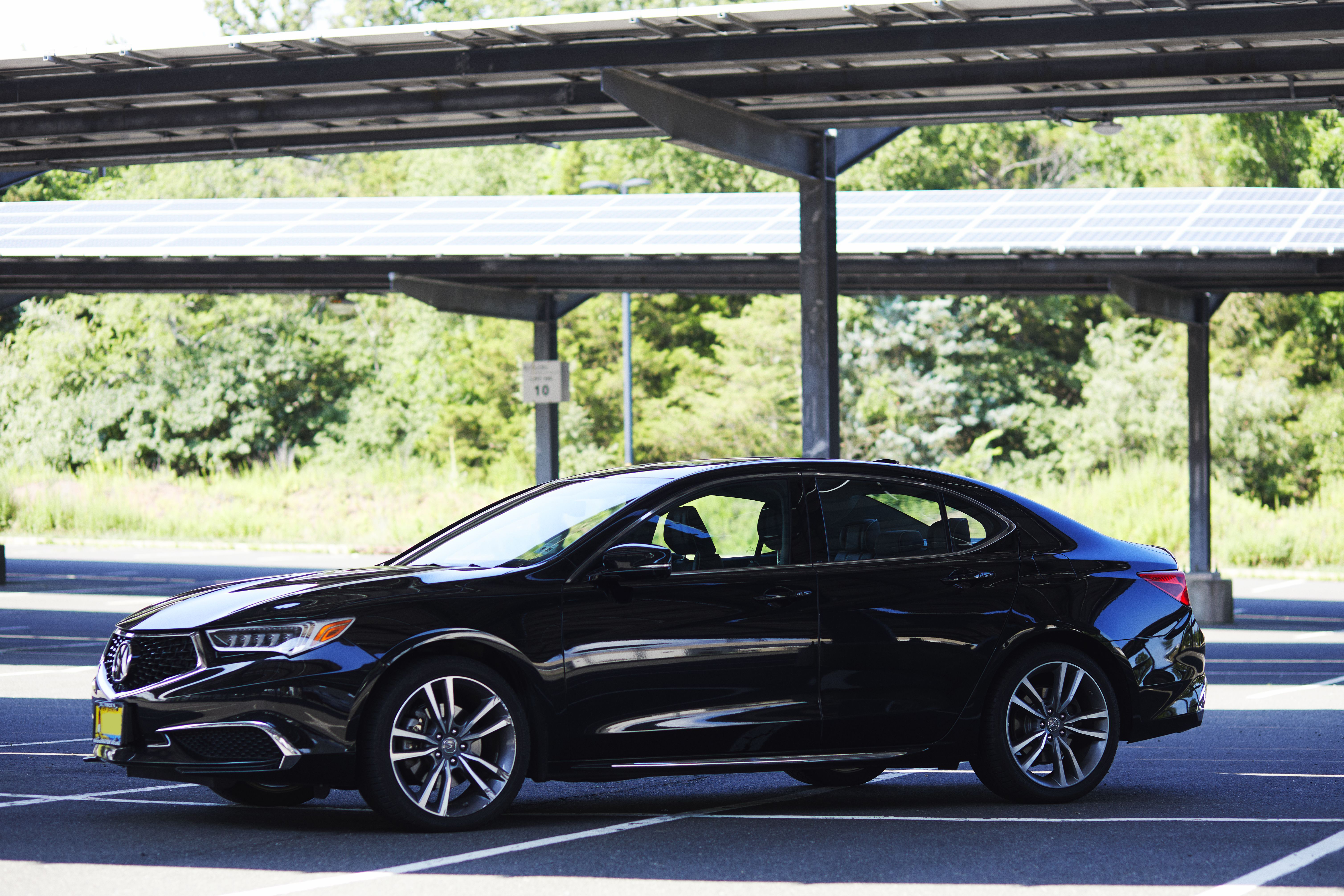2020 Acura TLX parked under solar panels in parking lot.