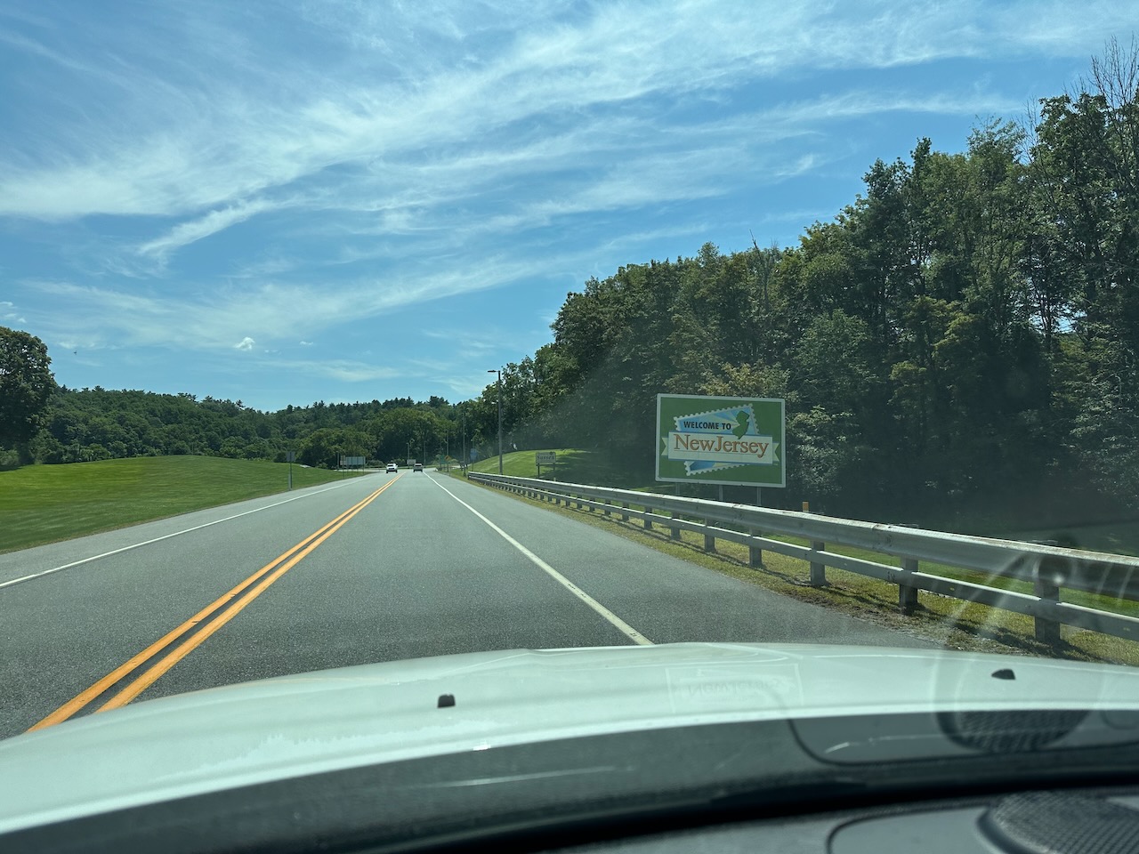 Welcome to New Jersey sign along highway.
