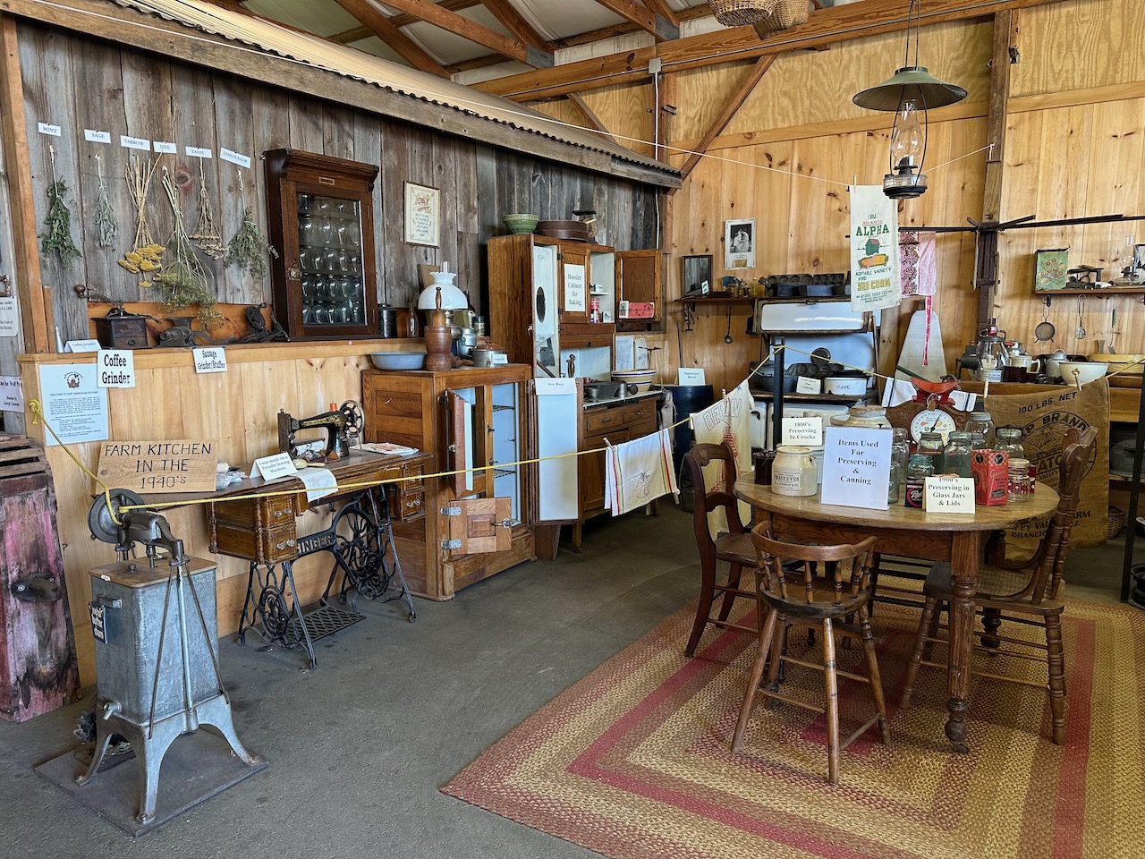 Exhibit of 1940s Farm Kitchen, with display filled with furniture and appliances of a kitchen from the 1940s.