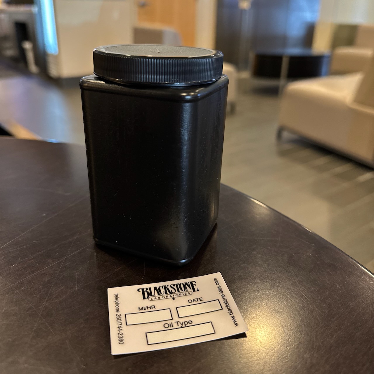 Oil sample container on waiting room table.