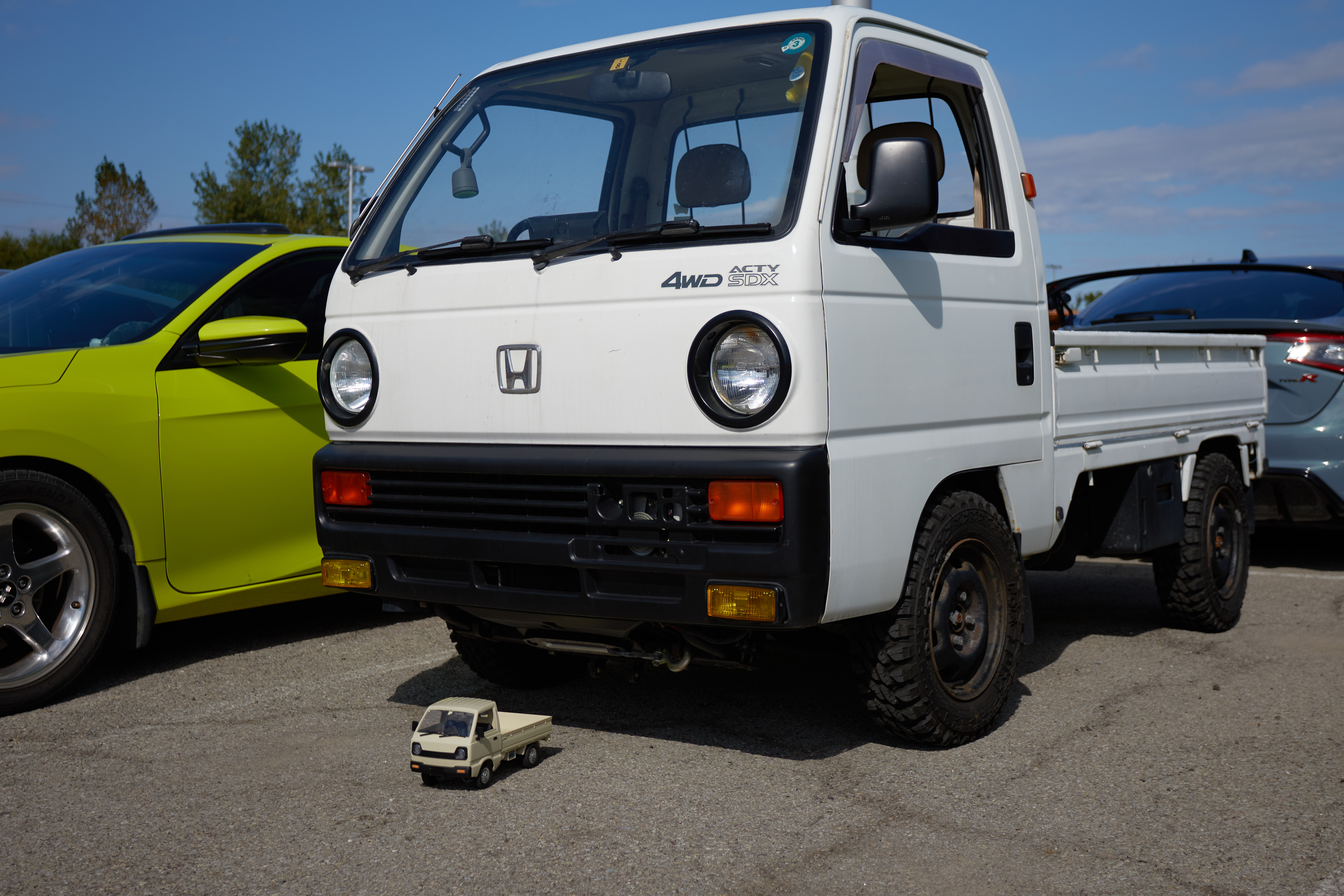 Honda Acty pickup with model of Honda Acty pickup in front of it.