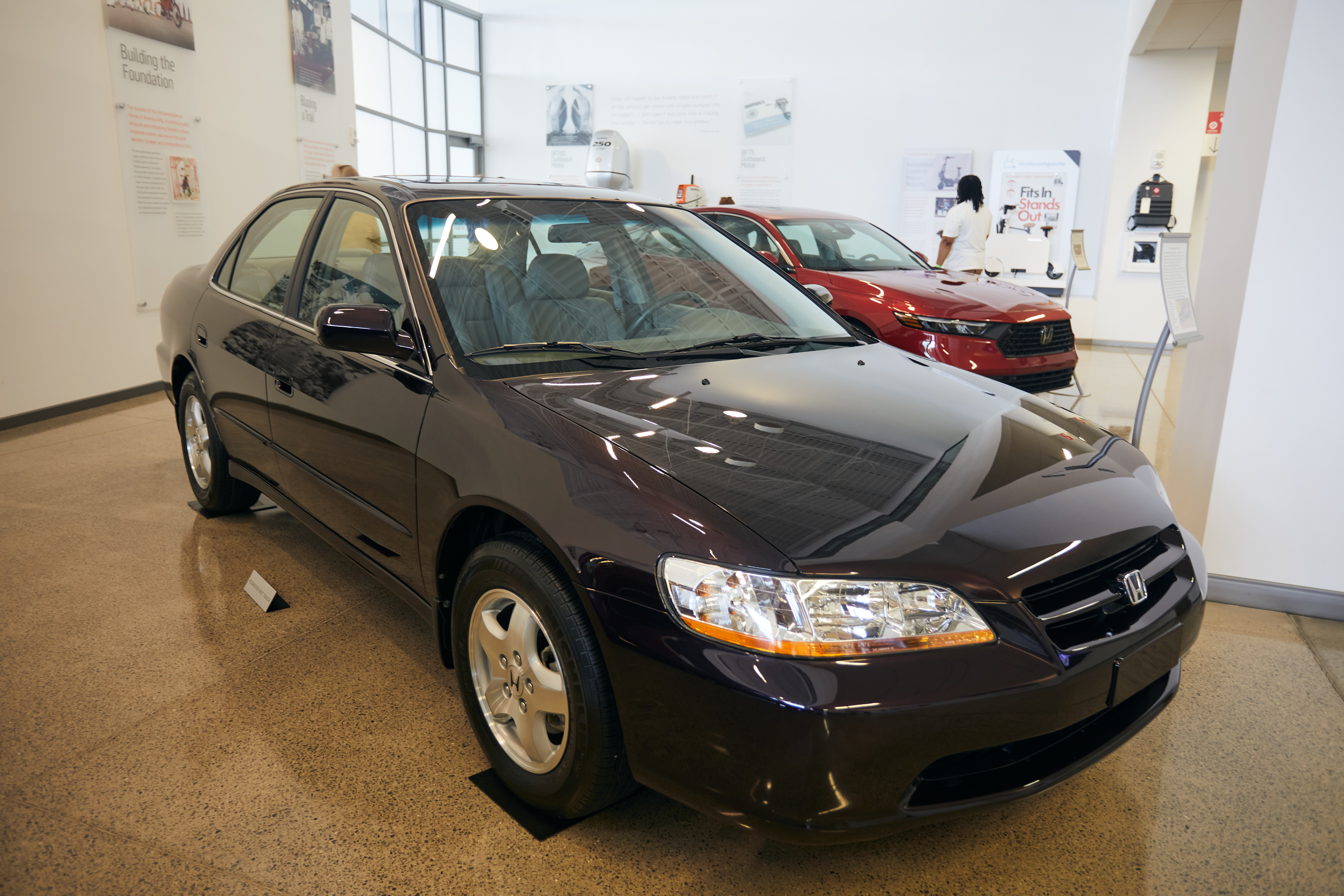 1998 Honda Accord sedan in black on museum floor.
