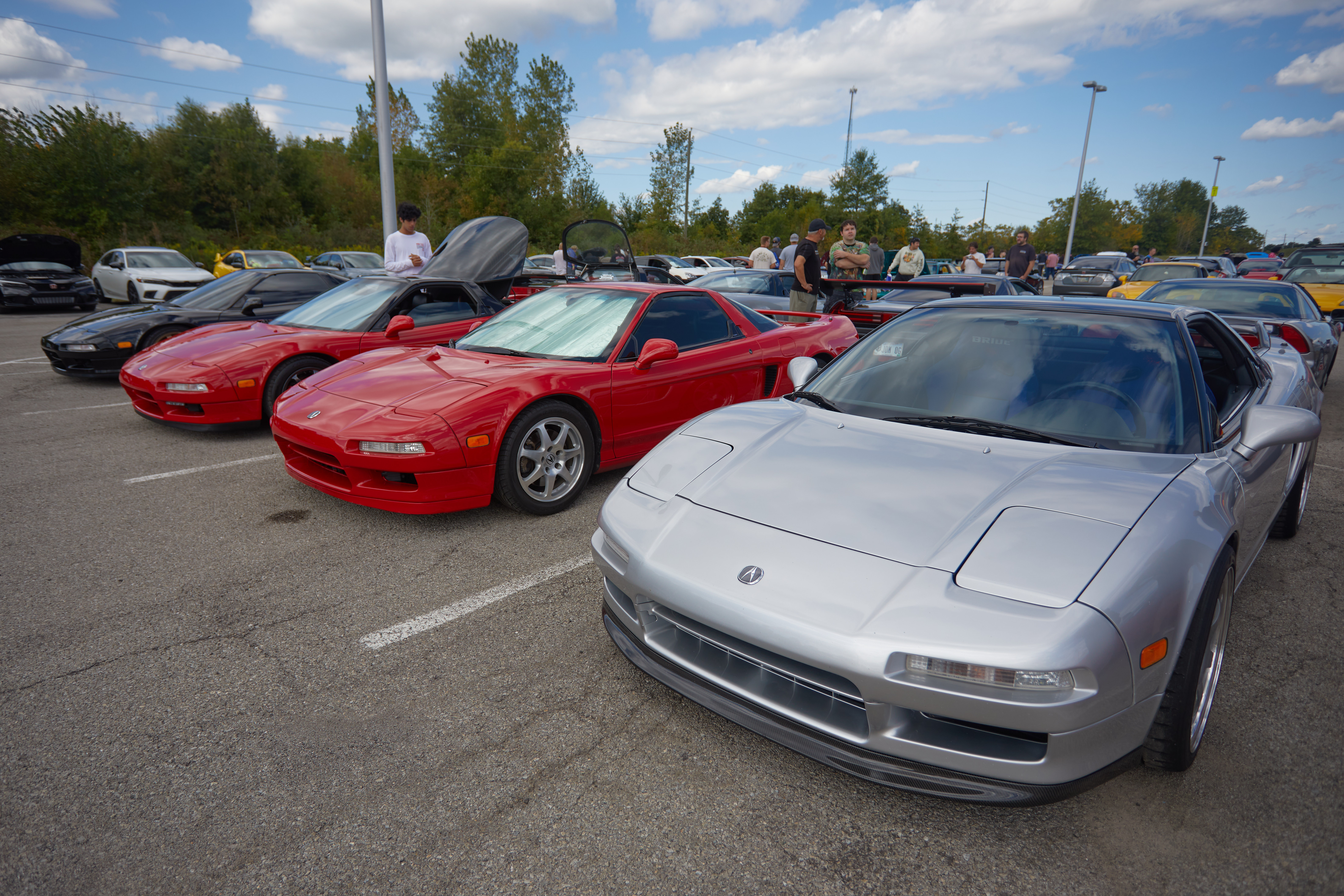 Row of Acura NSX cars in parking lot.