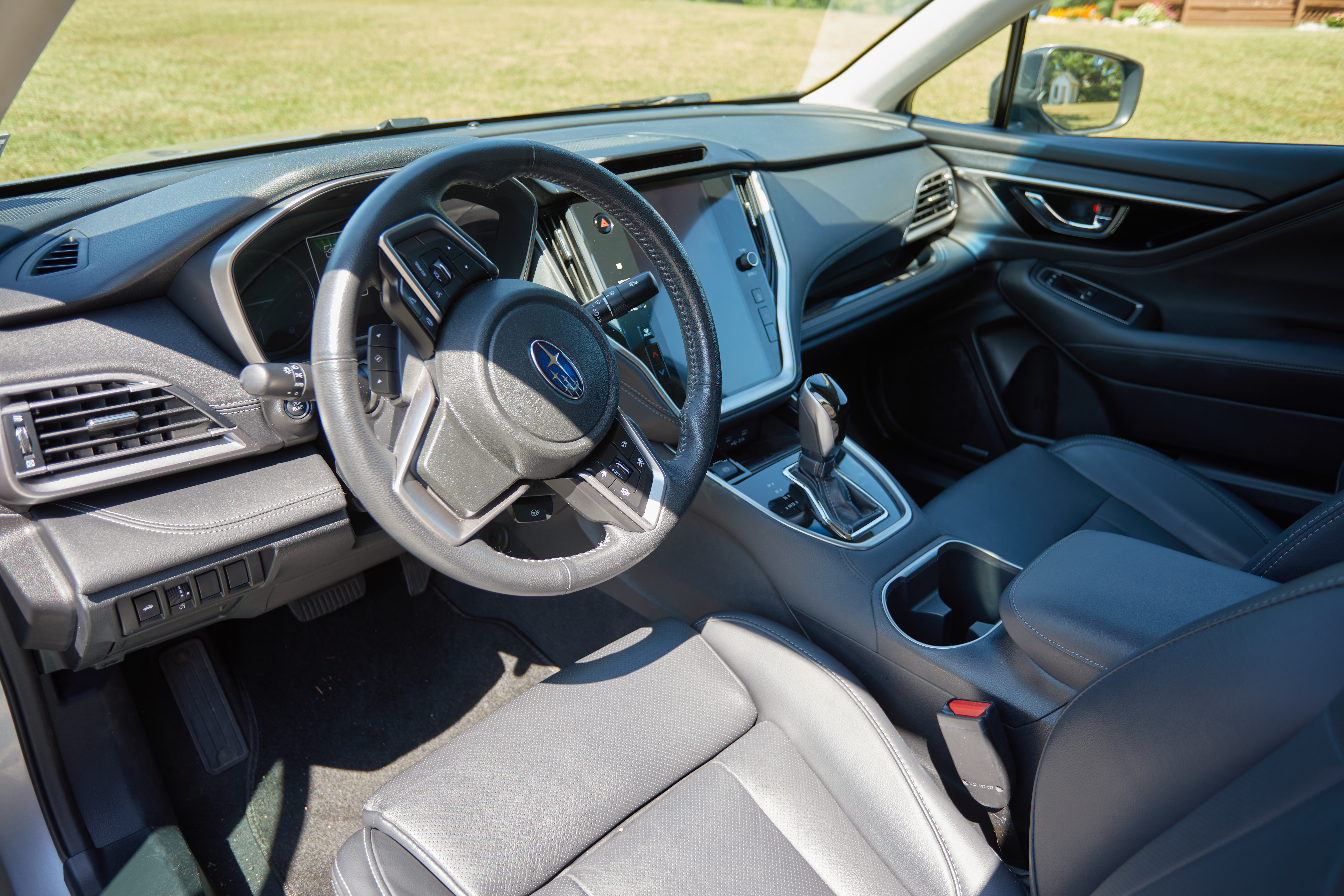 Interior of Subaru Legacy front seats and dashboard.