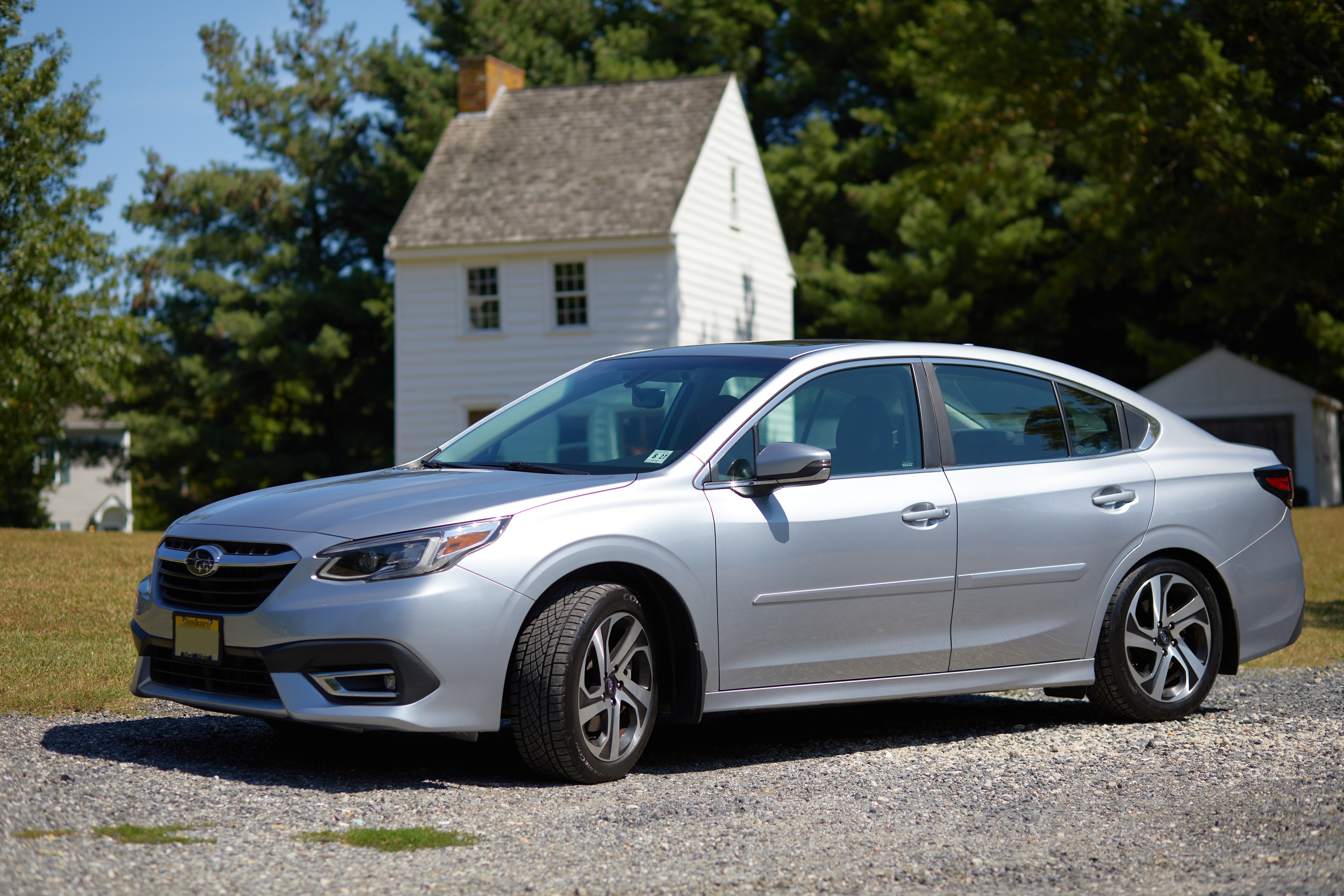 2022 Subaru Legacy sedan, in silver, with historic house in background.