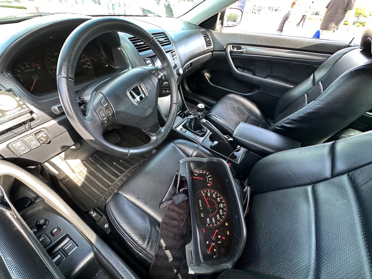 Interior of 2003 Honda Accord with gauge cluster on front seat.