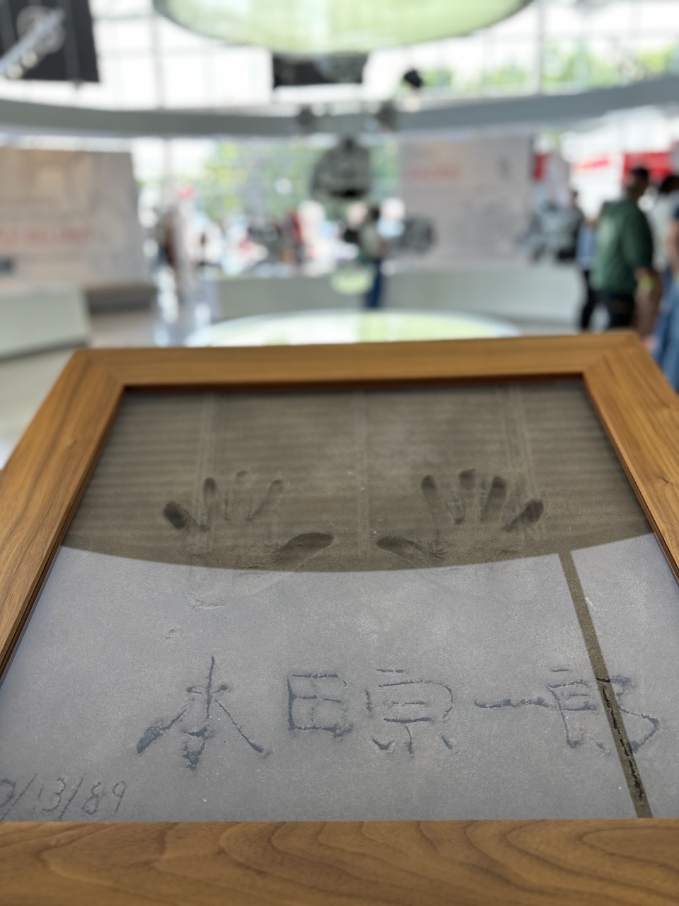 Hand prints in concrete, in wooden and glass display case.