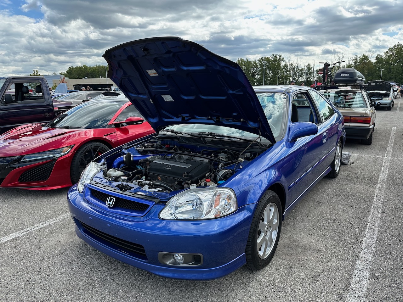 Honda Civic Si, in blue, with hood open.