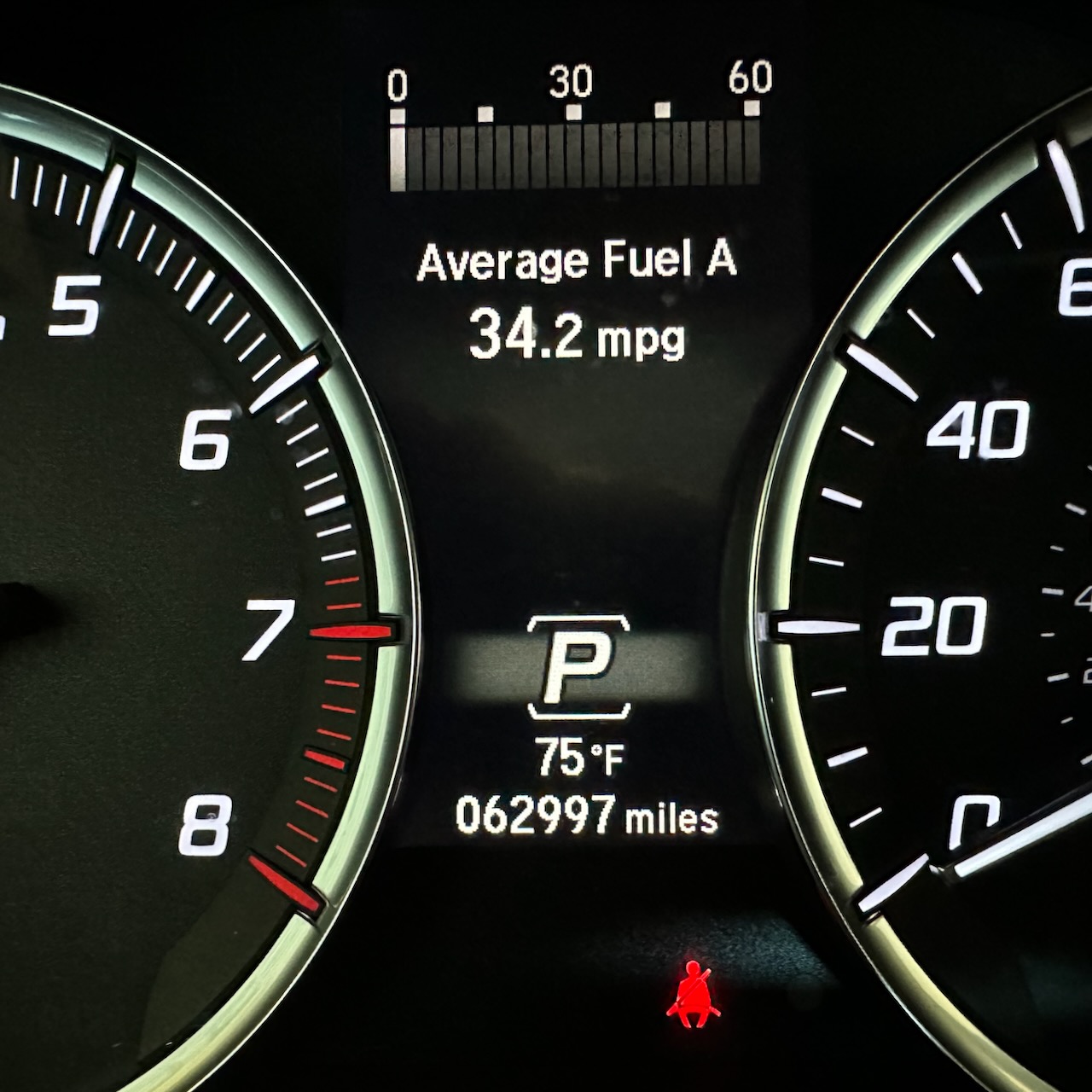 Car odometer reading 62997 miles.