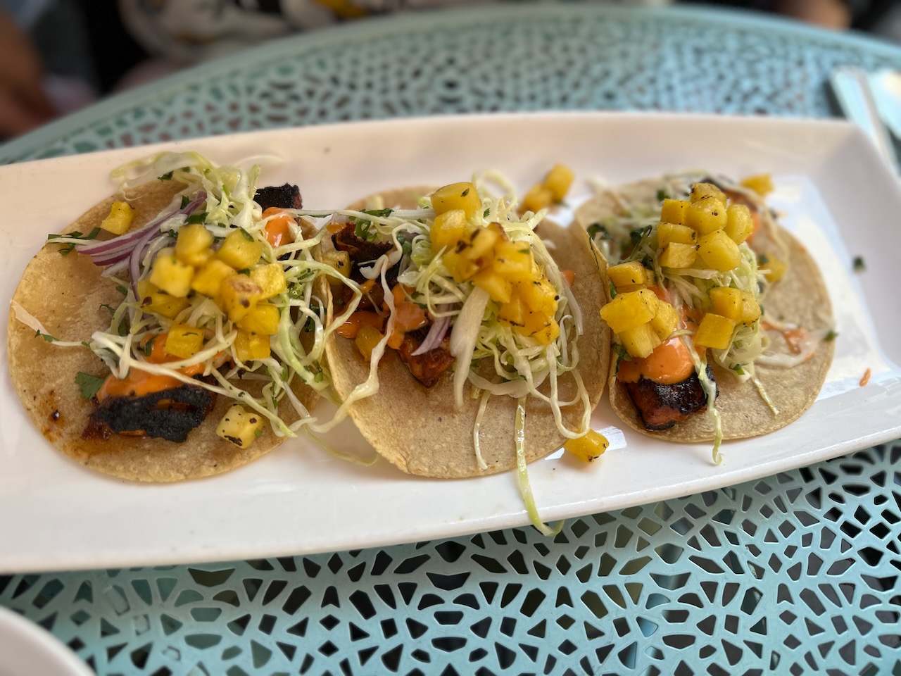 Order of fish tacos on white plate.