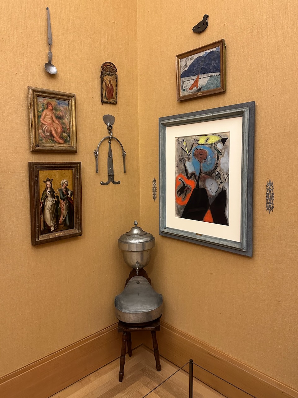 Paintings, sculpture and cistern in corner of room. 