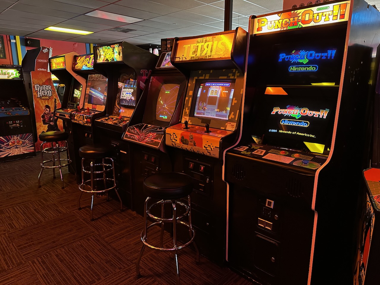 Line of video game cabinets including Punch-Out, Tetris, and others.