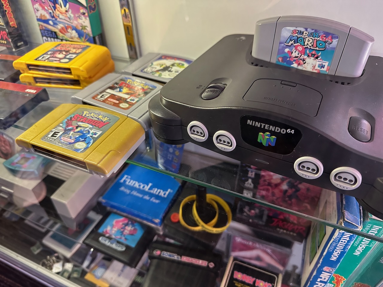 Nintendo 64 console with various game cartridges around it.