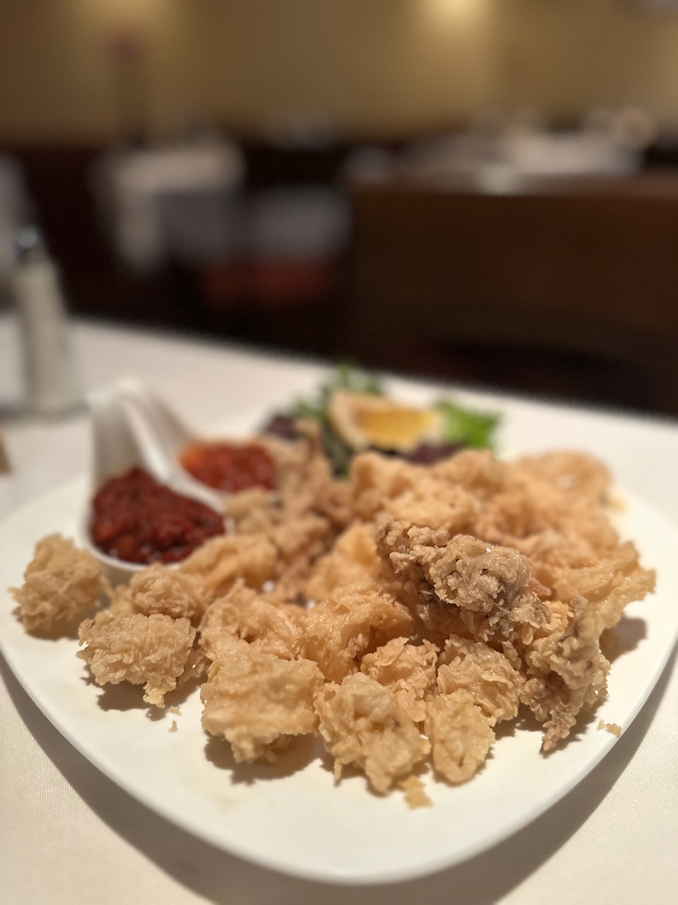 Fried calamari on white plate.