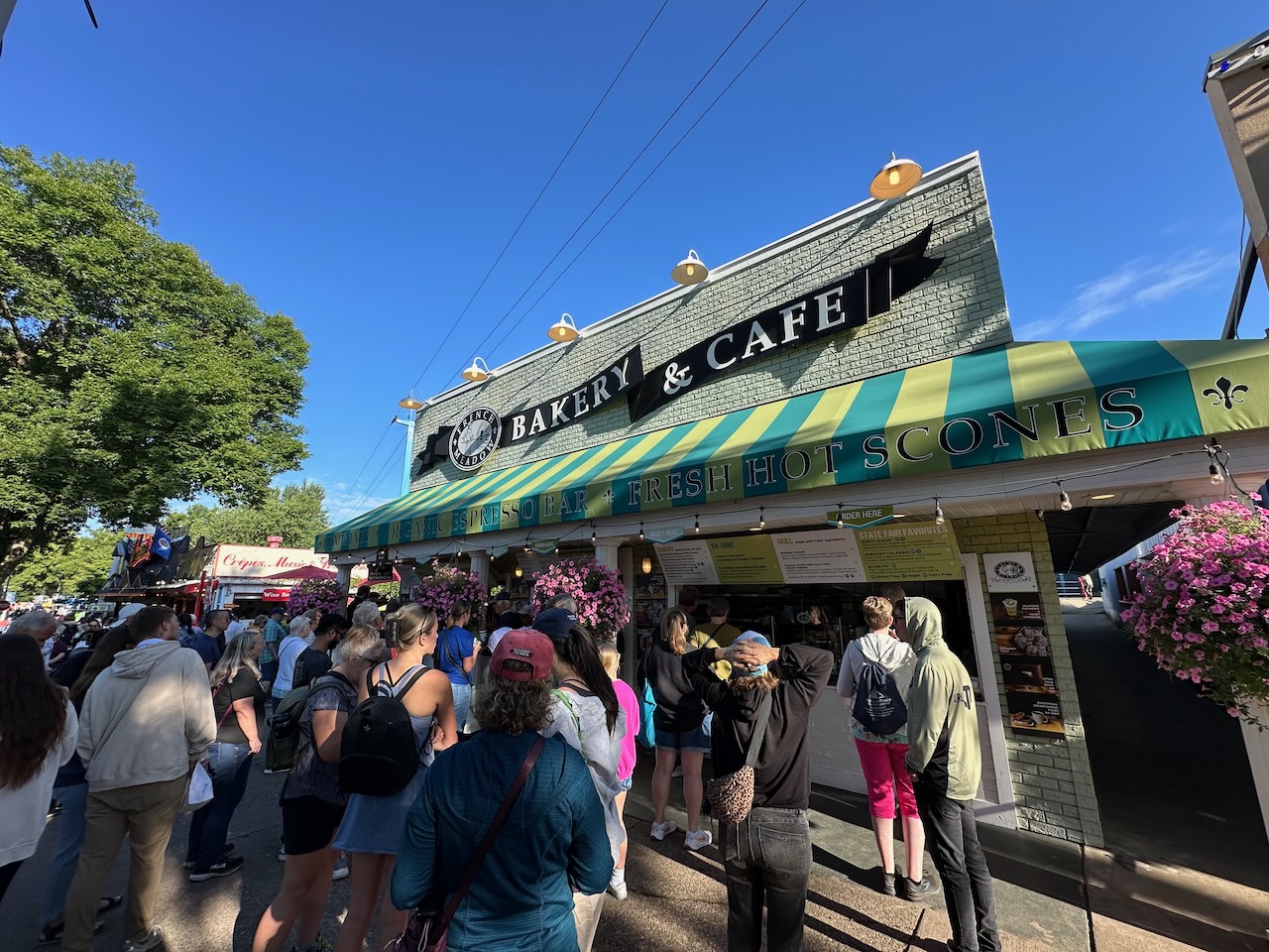 Exterior of French Meadow Bakery stand, with lines of people waiting to order.