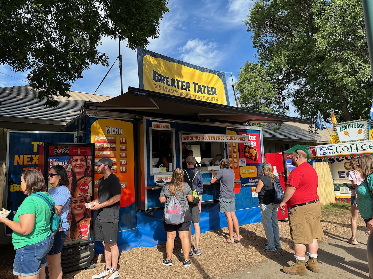 Greater Tater food stand, with people lined up for food.