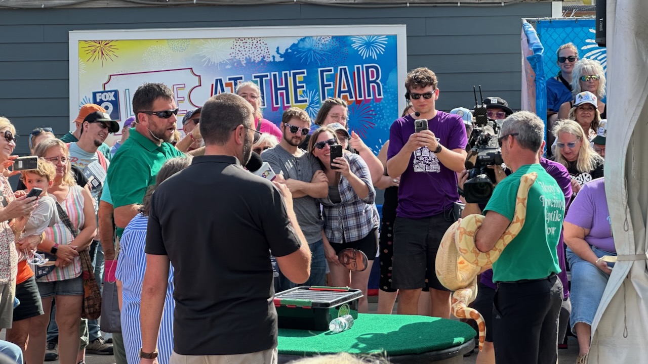Recording of The Jason Show, with guest holding large python in front of crowd.