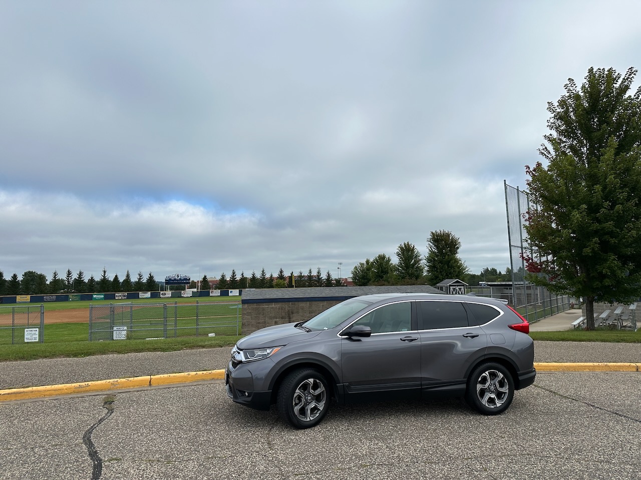 2019 Honda CR-V parked beside baseball field.