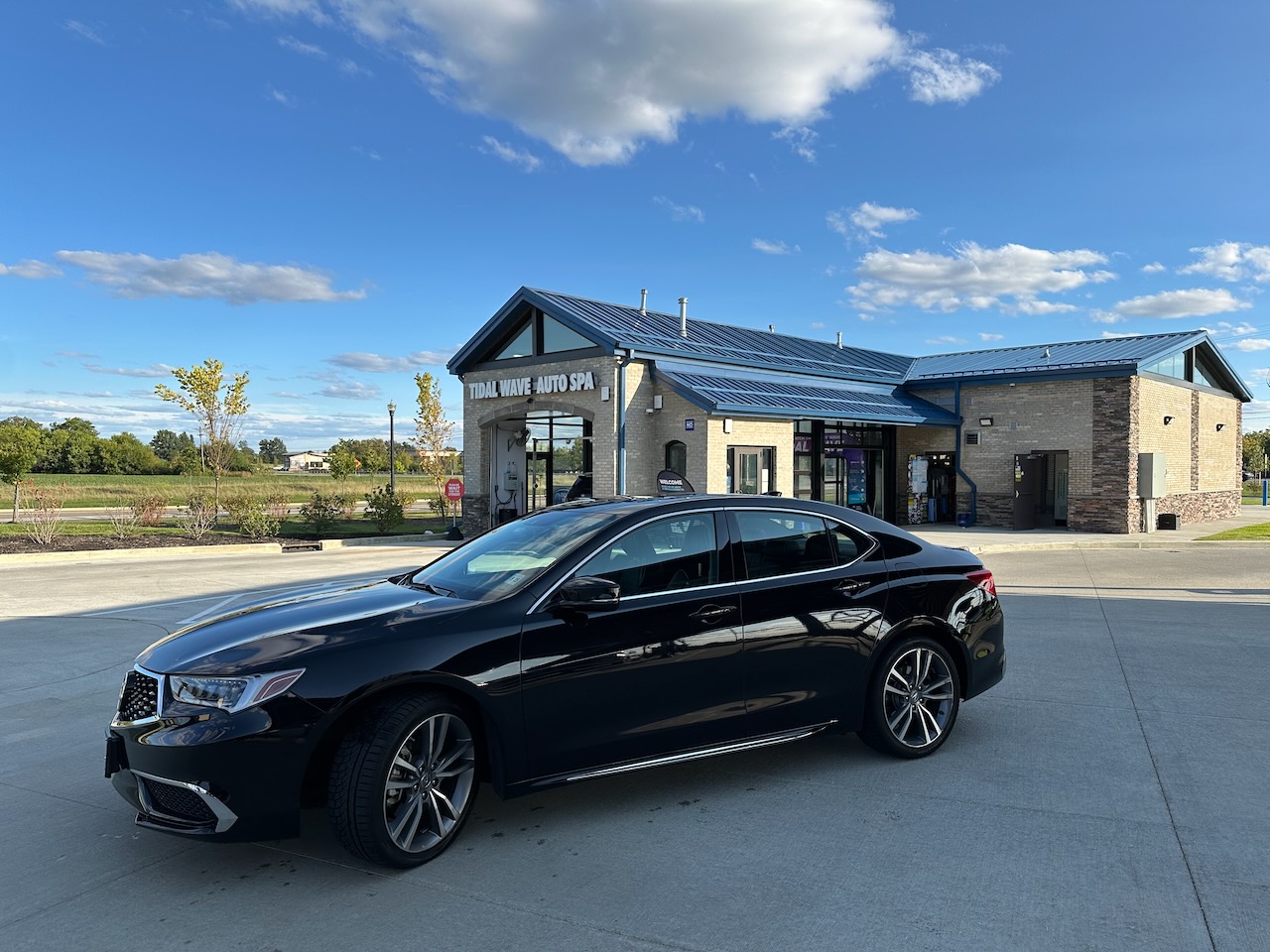 2020 Acura TLX parked in front of Tidal Wave car wash. 