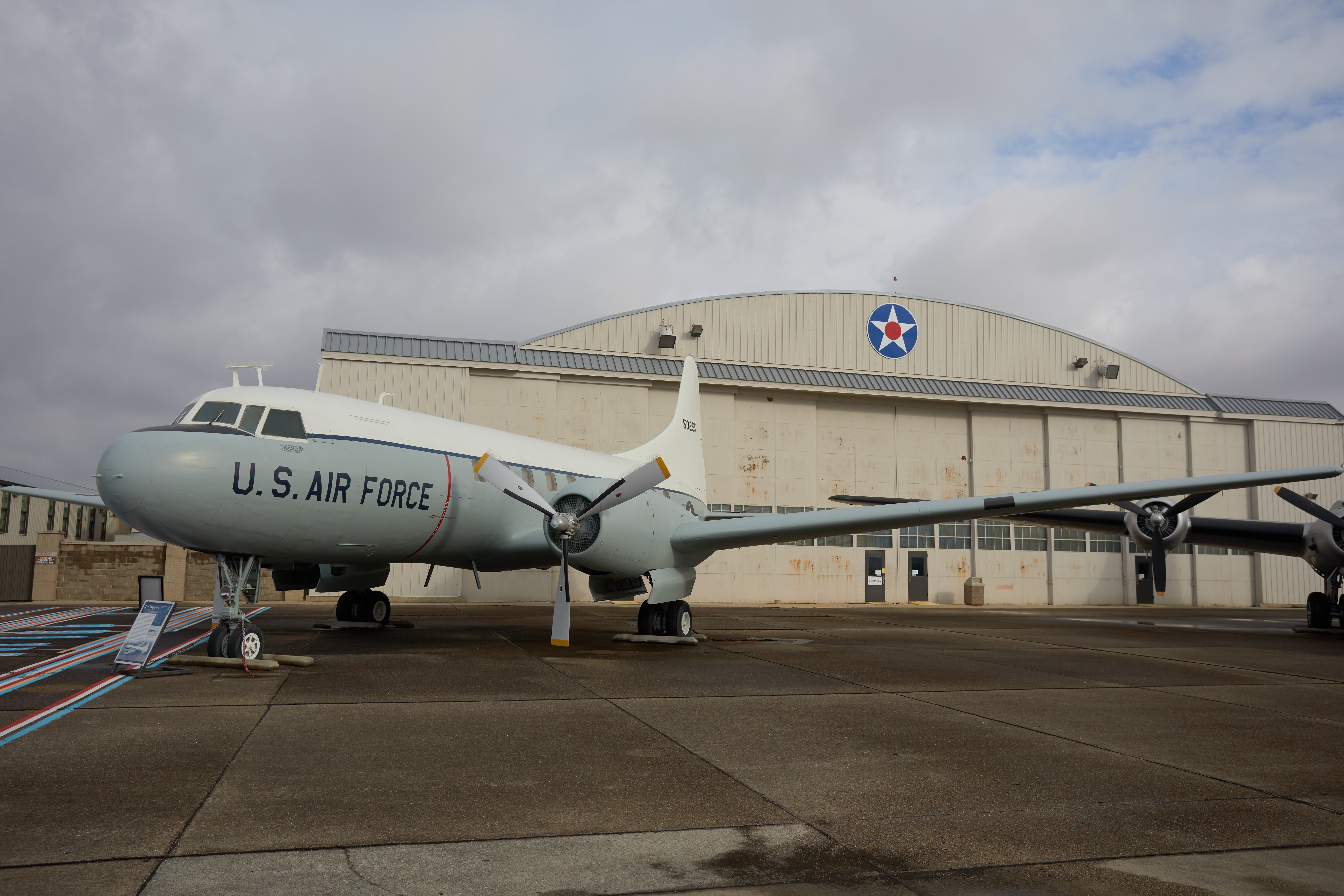 C-131D Samaritan cargo plane in front of hanger. 