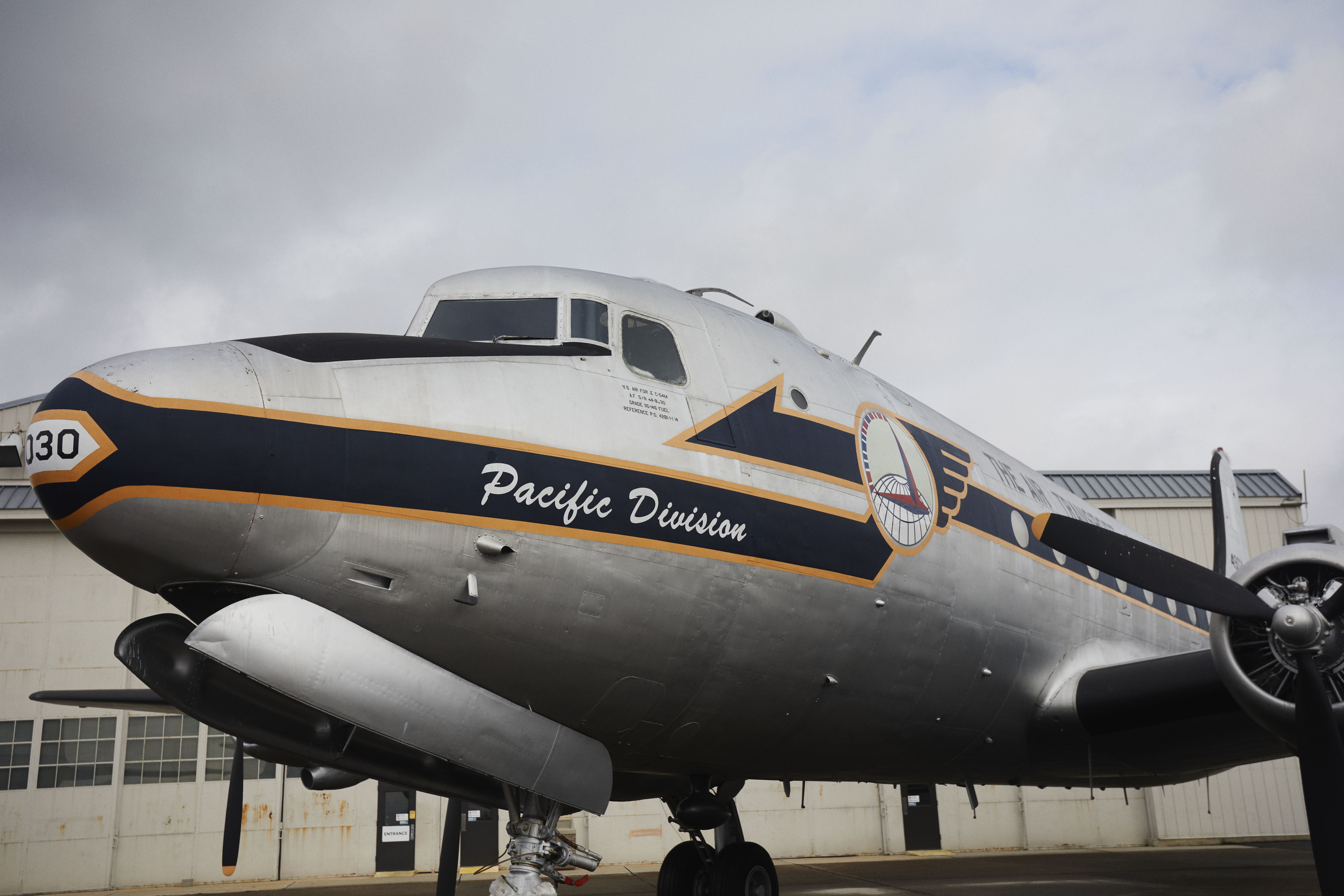 Exterior of C-54M Spymaster with nose art that says PACIFIC DIVISION.