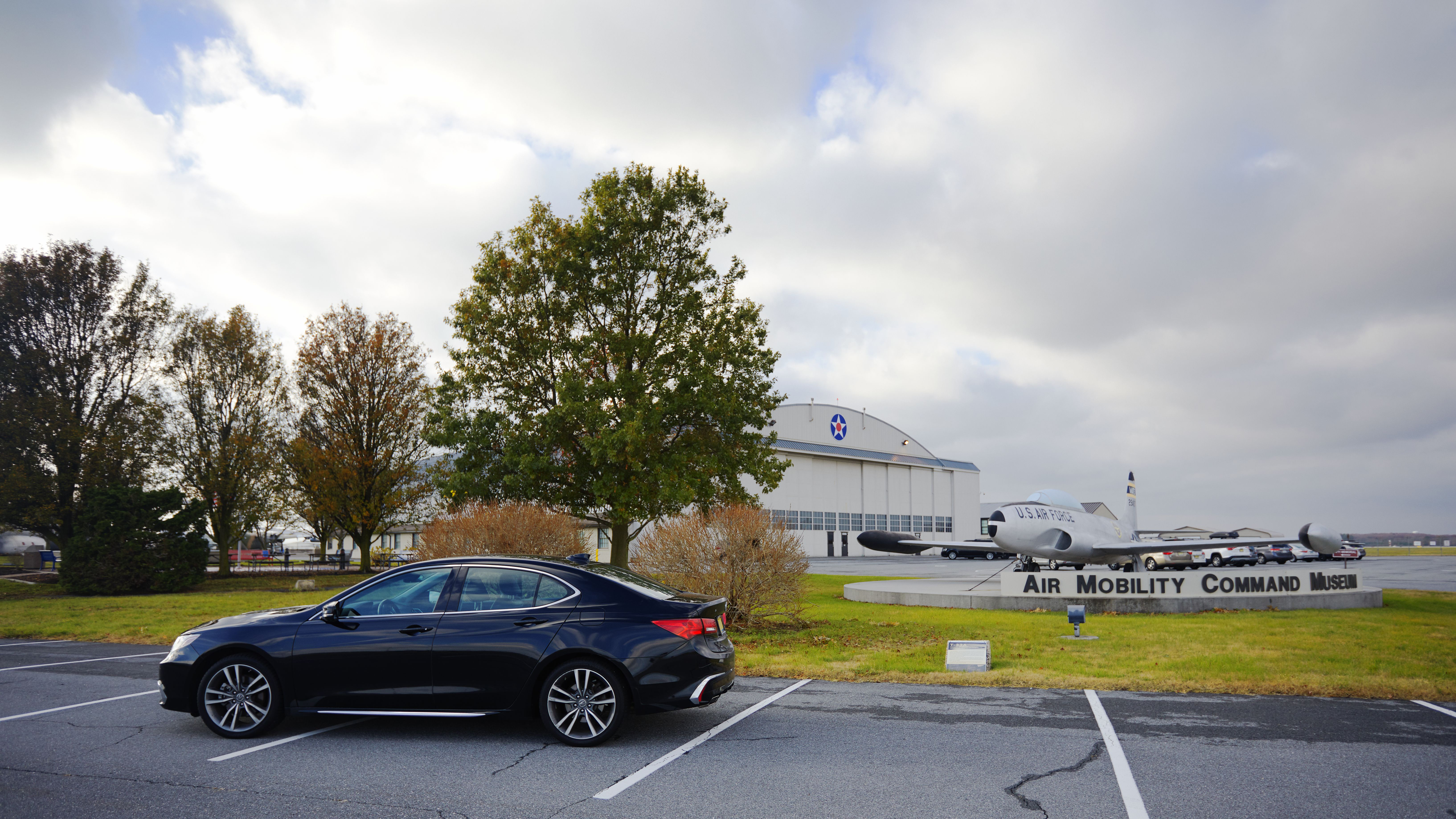 2020 Acura TLX parked in front of Air Mobility Command Museum statue, with hanger in distance. 
