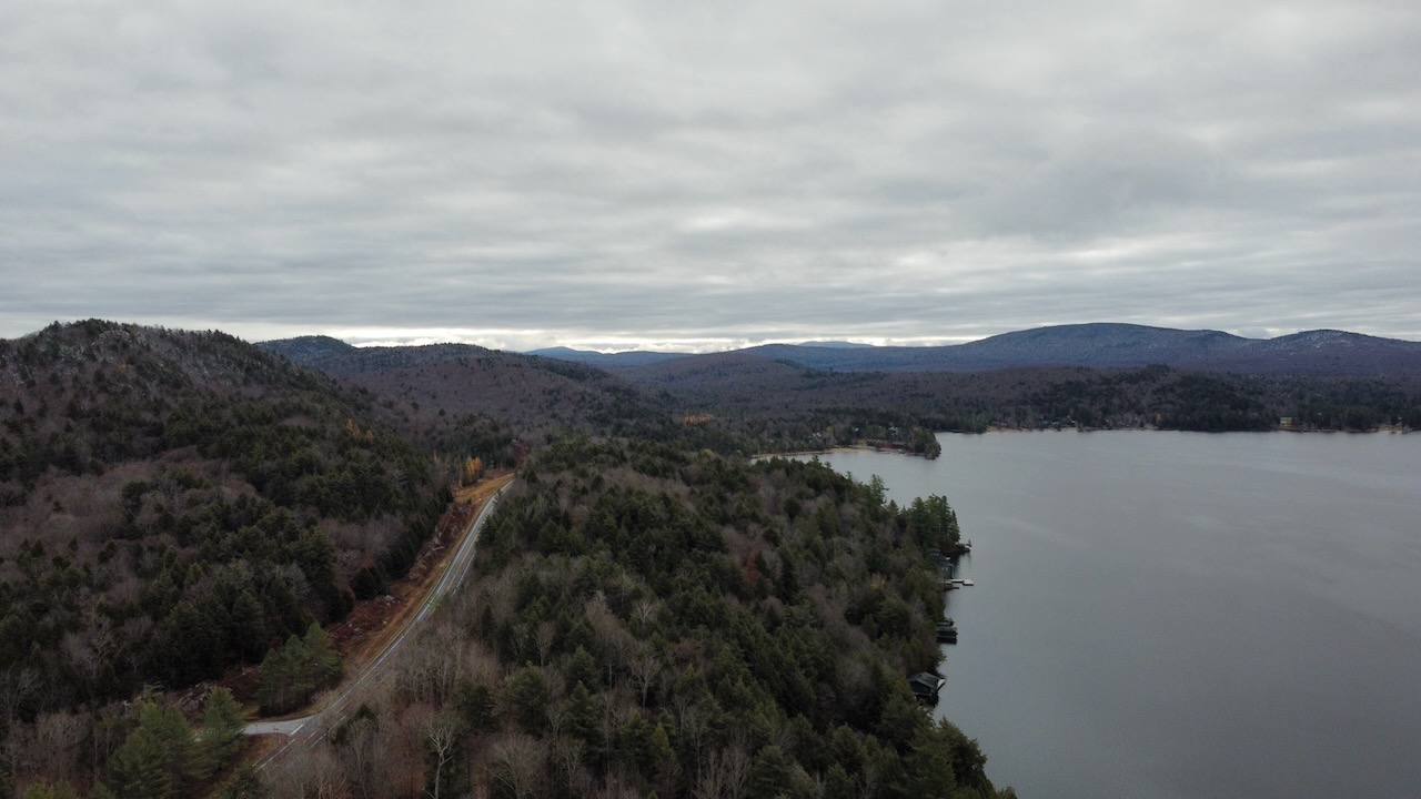 Drone photo of Fourth Lake and surrounding mountains. NY-28 is visible in the lower left corner.
