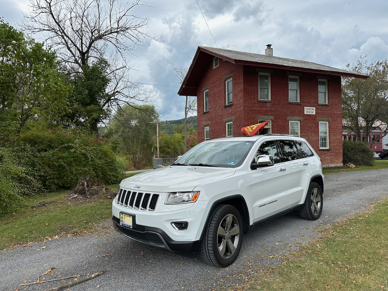 2014 Jeep Grand Cherokee parked in front of 19th century train station.
