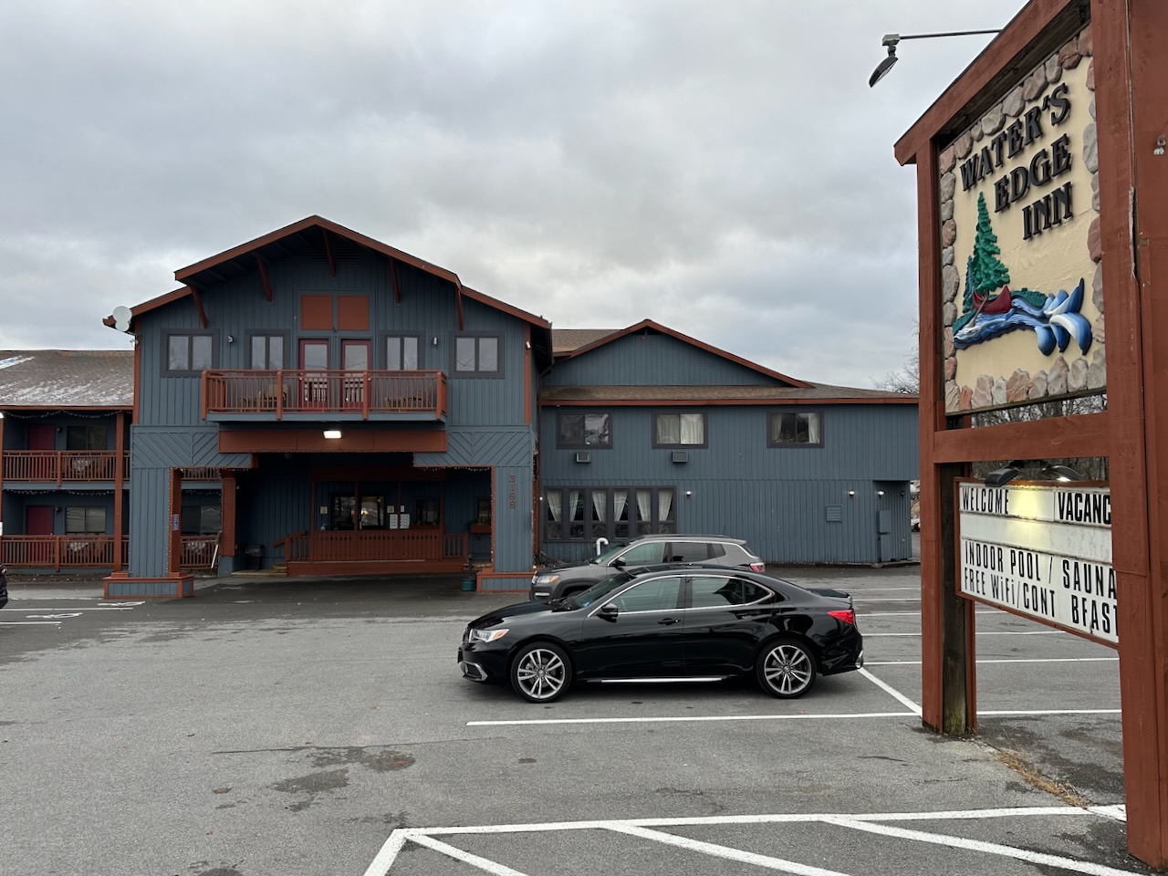 2020 Acura TLX parked in front of Water's Inn lodge.