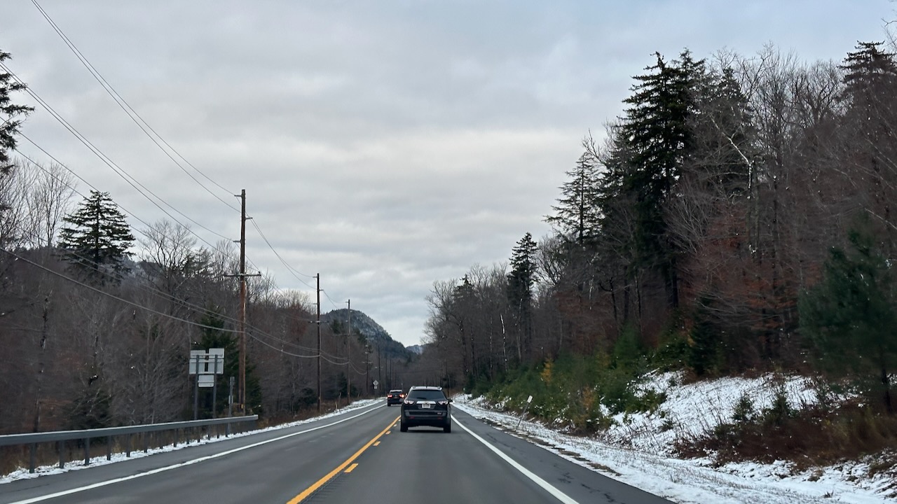 NY-28 with snow on either side of road.