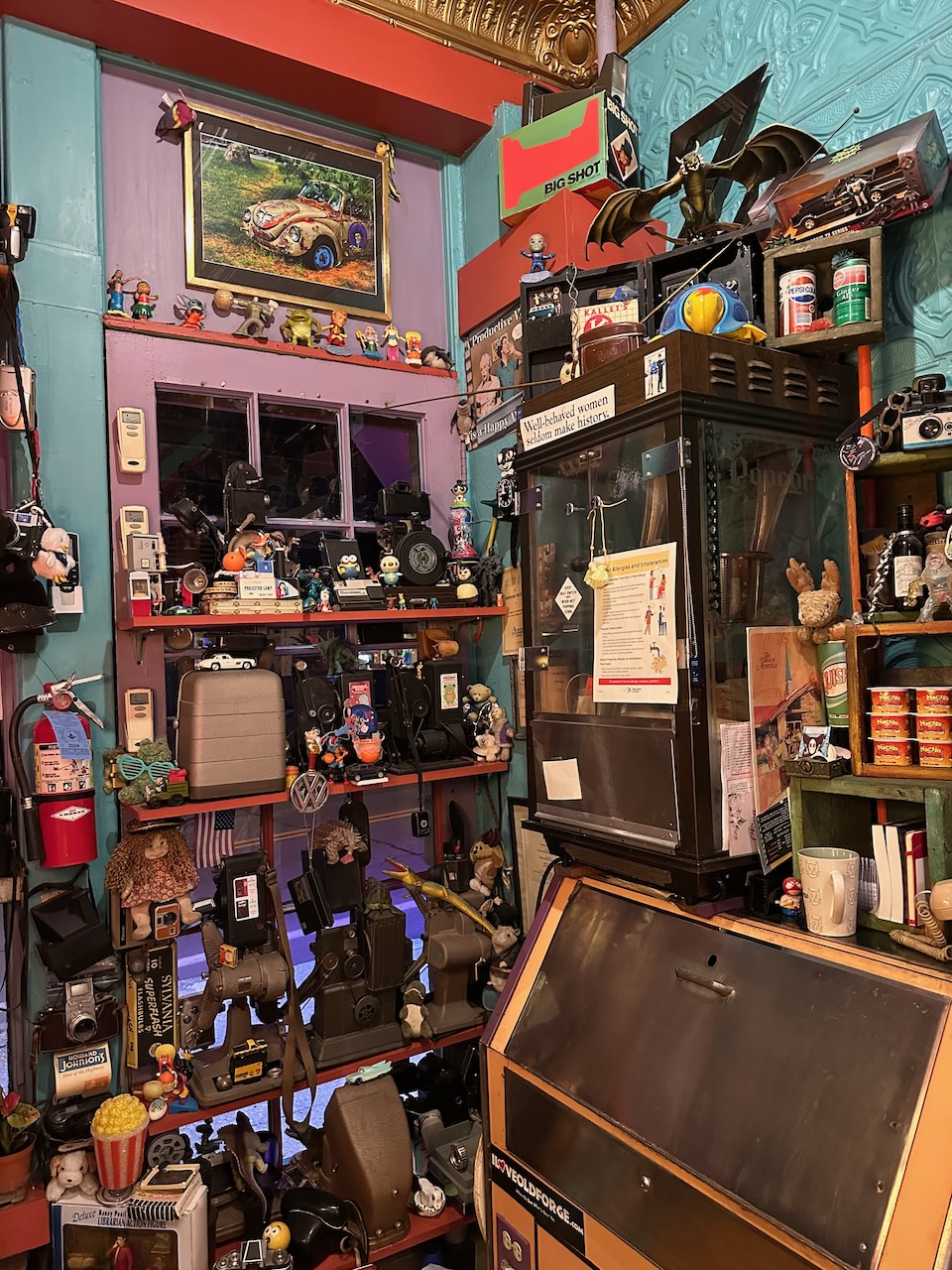Display of old cameras, toys, vintage movie theater snack machines, and other memorabilia.