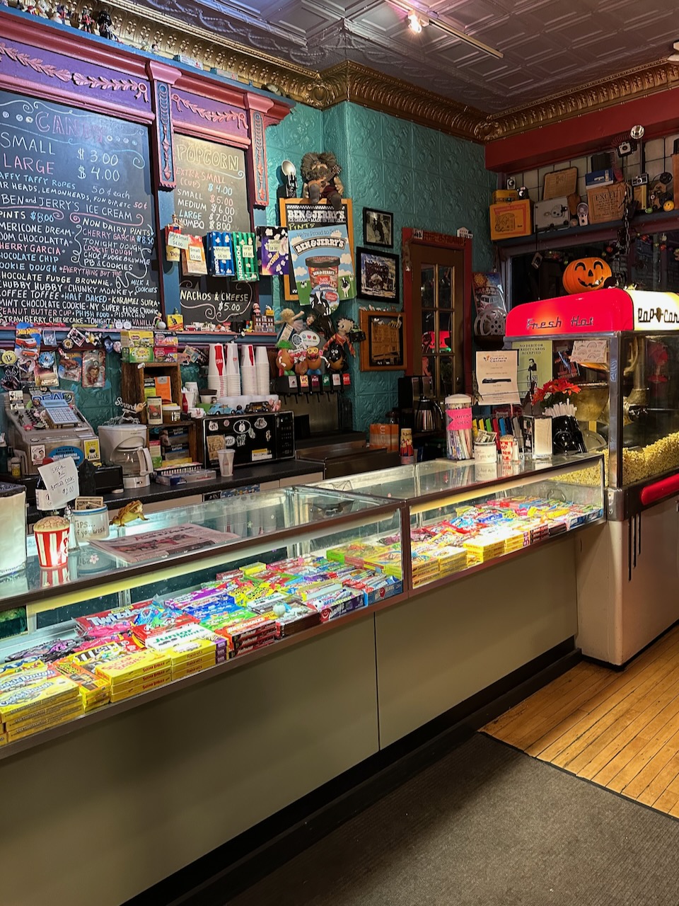 Snack counter in The Strand theater, with popcorn machines and candy counter.