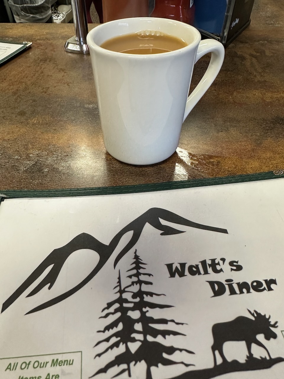 Coffee and menu on counter at Walt's Diner